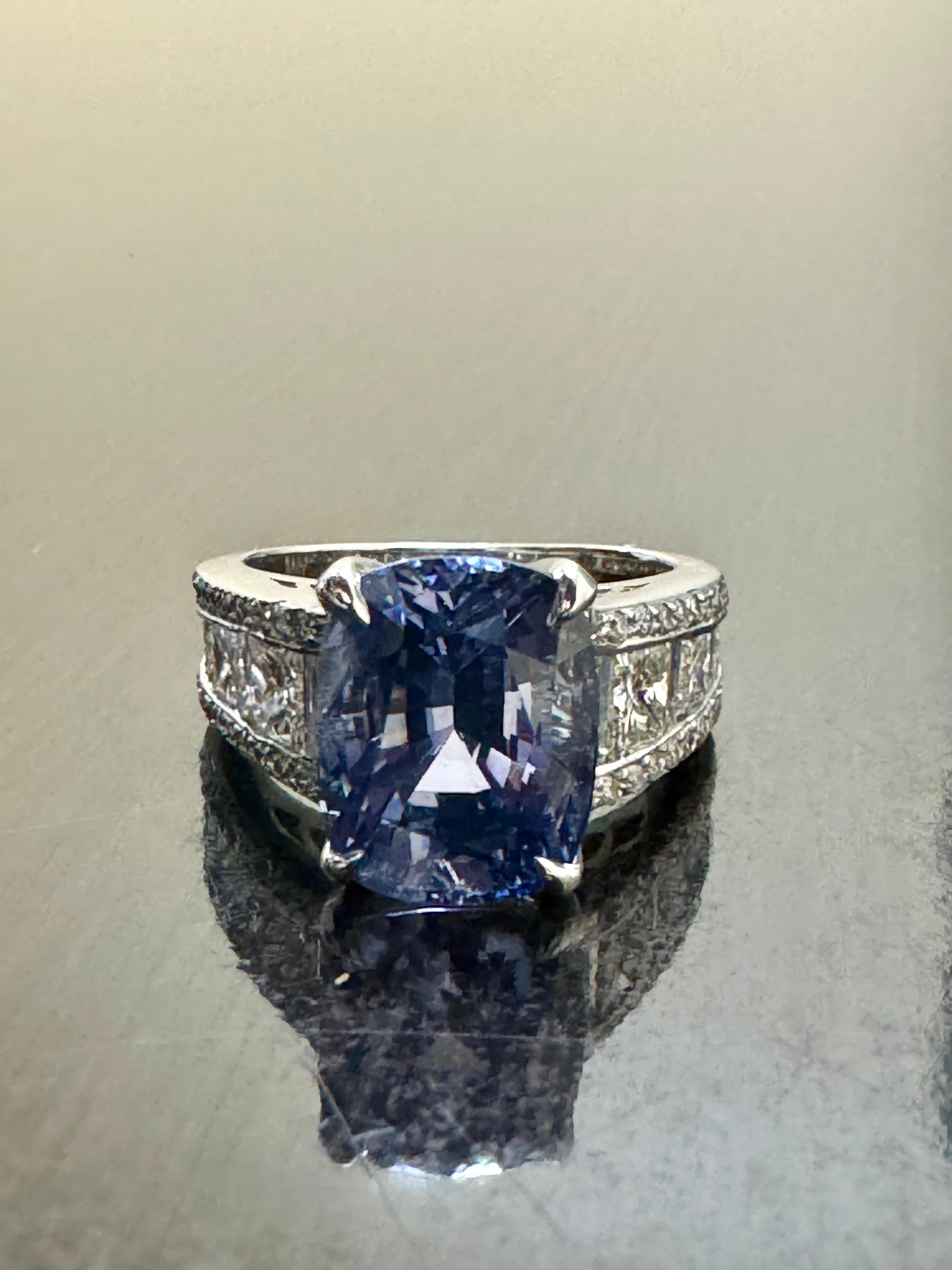 DeKara Designs Designer Collection

Beautiful Modern/Art Deco Inspired Ceylon Blue Sapphire and Diamond Ring.

Metal- 18K White Gold, .750.

Stones- GIA Certified Cushion Cut No Heat Sapphire 8.12 Carats.  6 Specially Cut Princess Cut Diamonds, 8