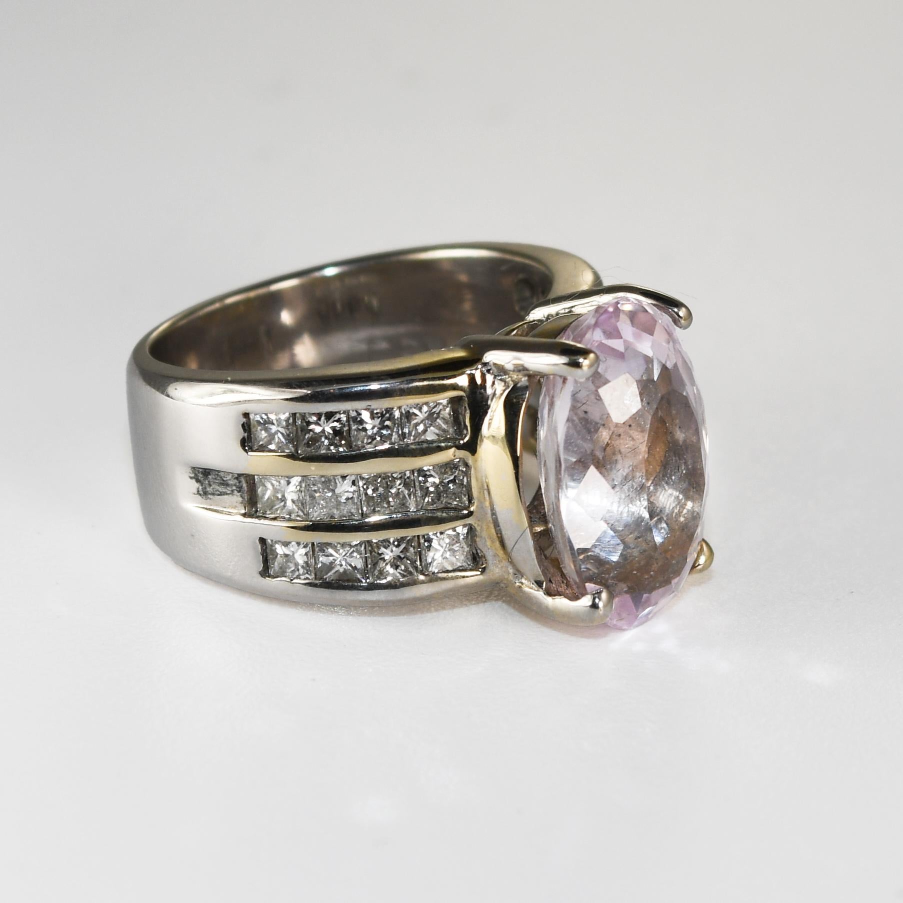 Kunzite and diamond ring in 18k white gold.
Stamped 18k and weighs 13.7 grams.
The oval shape kunzite weighs 6.56 carats, light pink color, excellent cut.
The side diamonds are princess cuts, 1.00 total carats, H color, VS clarity. 
The ring size is