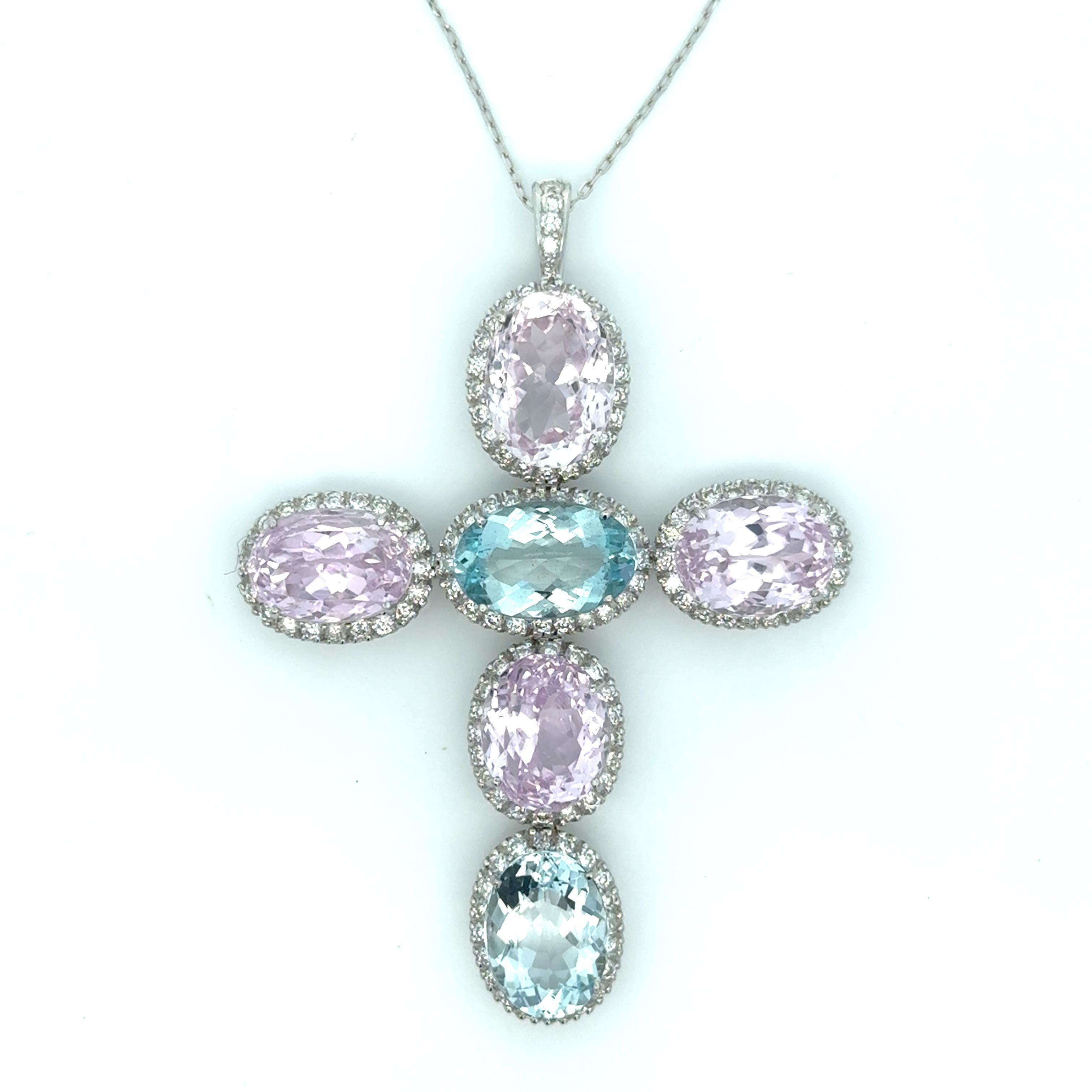 Elevate your jewelry collection with our 18K White Gold Cross Necklace. Featuring a stunning large cross pendant adorned with Kunzite and Aquamarine gemstones, each with a sparkling diamond halo. Make a statement with this one-of-a-kind
