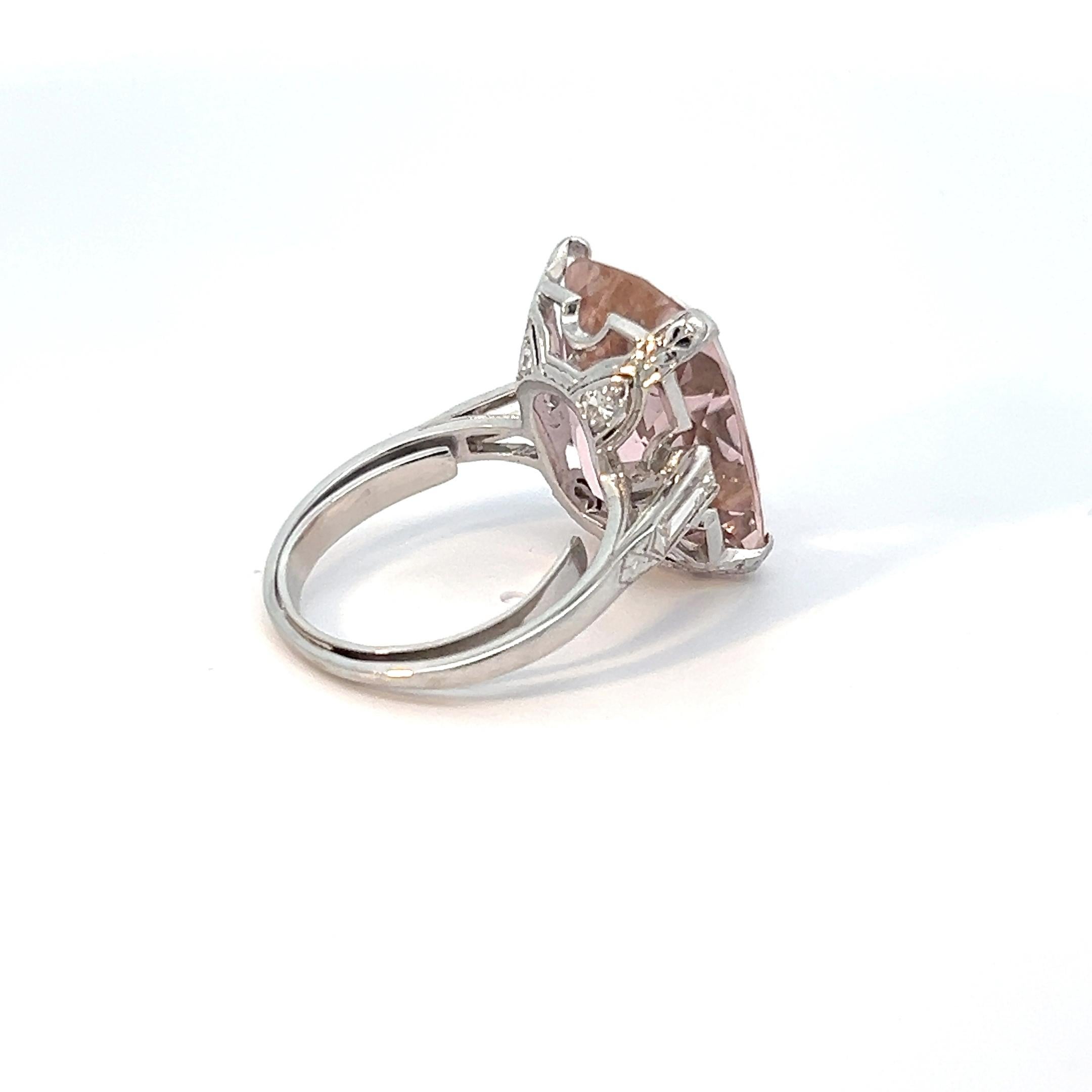 Indulge in the ethereal allure of this exquisite 18k white gold ring, a mesmerizing embodiment of elegance and sophistication. The focal point of this stunning piece is a resplendent kunzite or morganite. Its delicate pink hue exudes a captivating