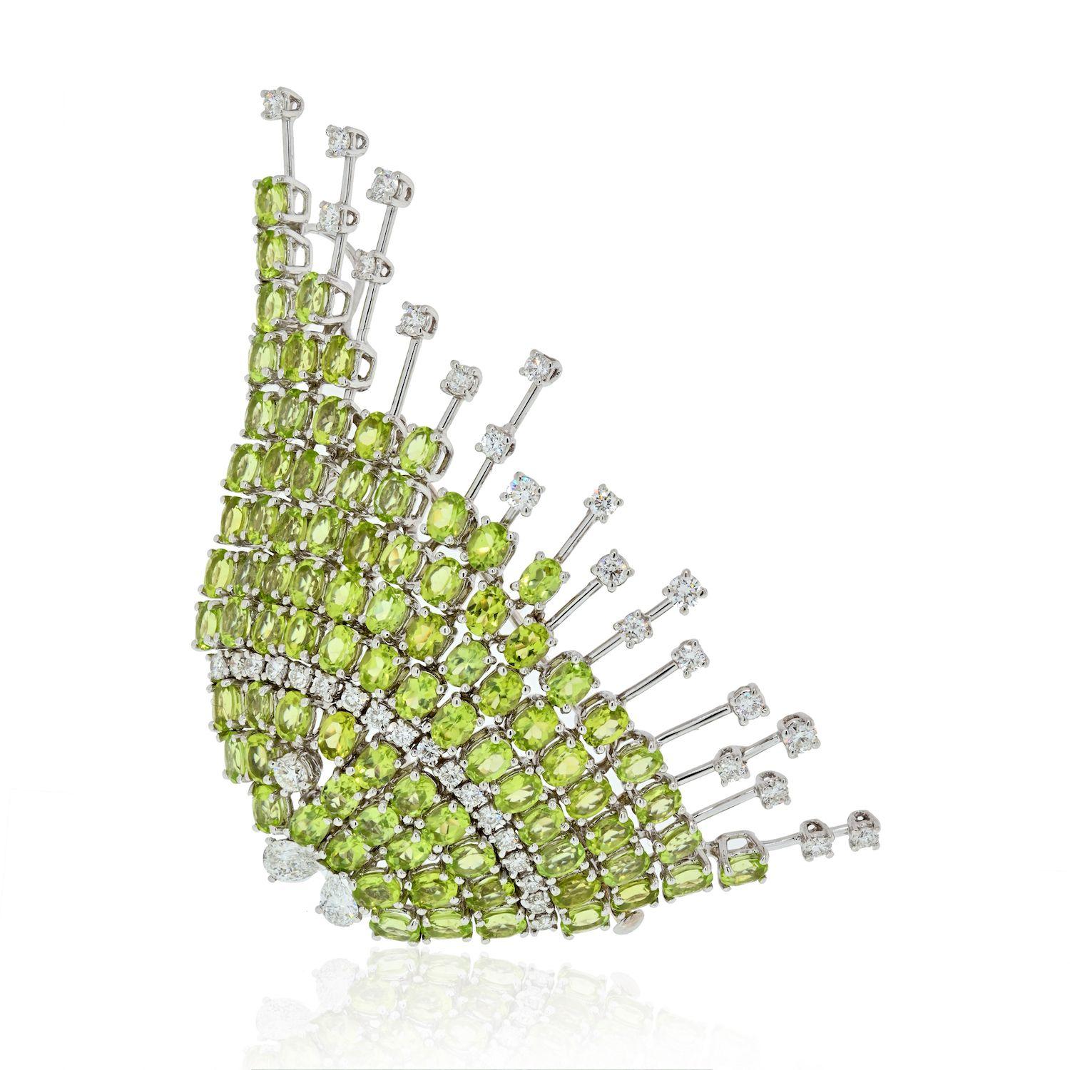 This is a funky brooch designed as a fish, can you see it?
She is encrusted with oval cut light green peridots that shine very nicely in the daylight giving out soft green apple color. There are round cut diamonds on the tips of her fountain wires
