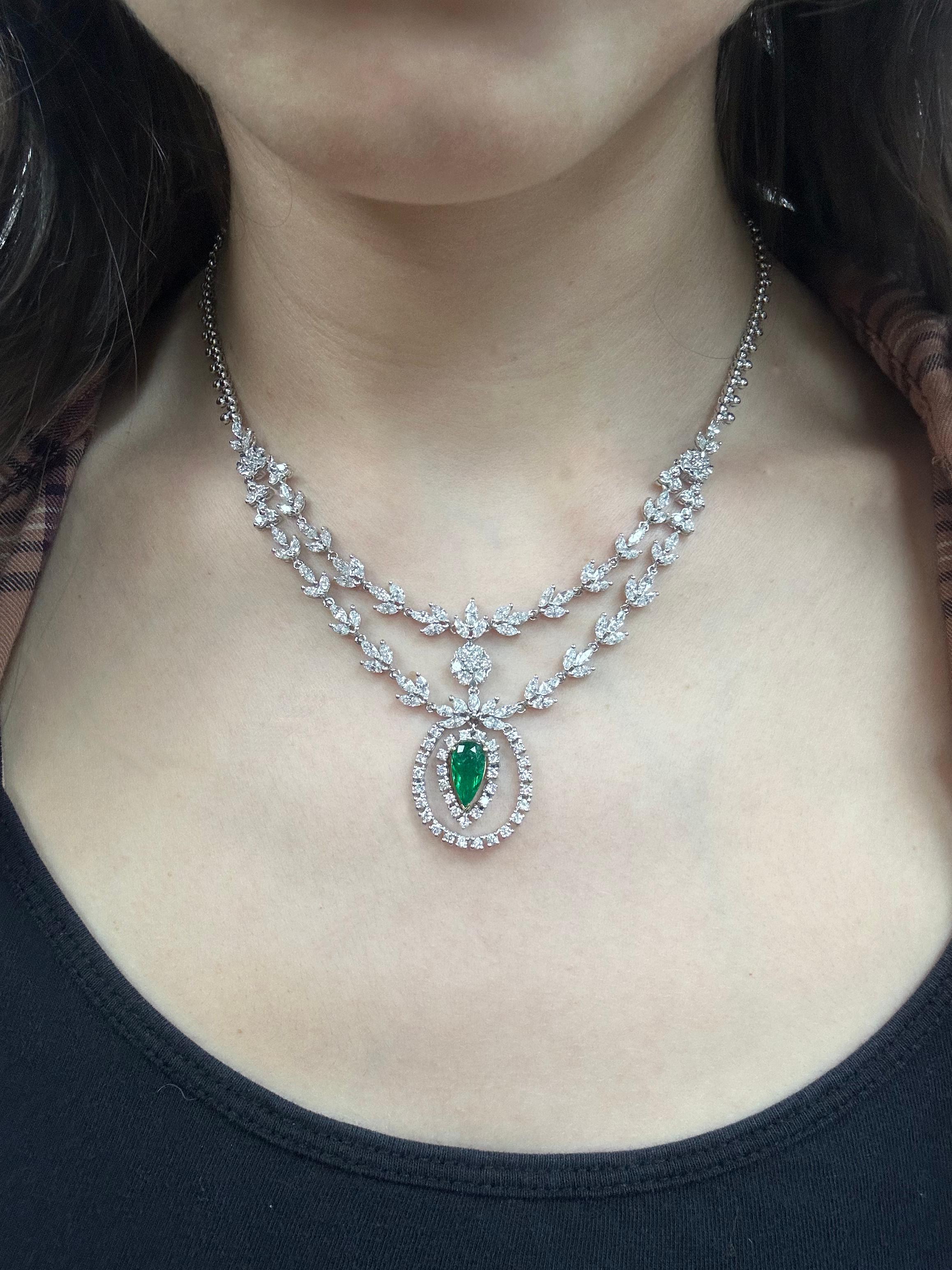 Crafted in luminous 18K white gold, this elegant necklace features a striking 1.19 carat pear cut emerald at its center, framed by 5.25 carats of marquise cut diamonds and 2.24 carats of accent diamonds. The 15.50-inch design showcases an exquisite