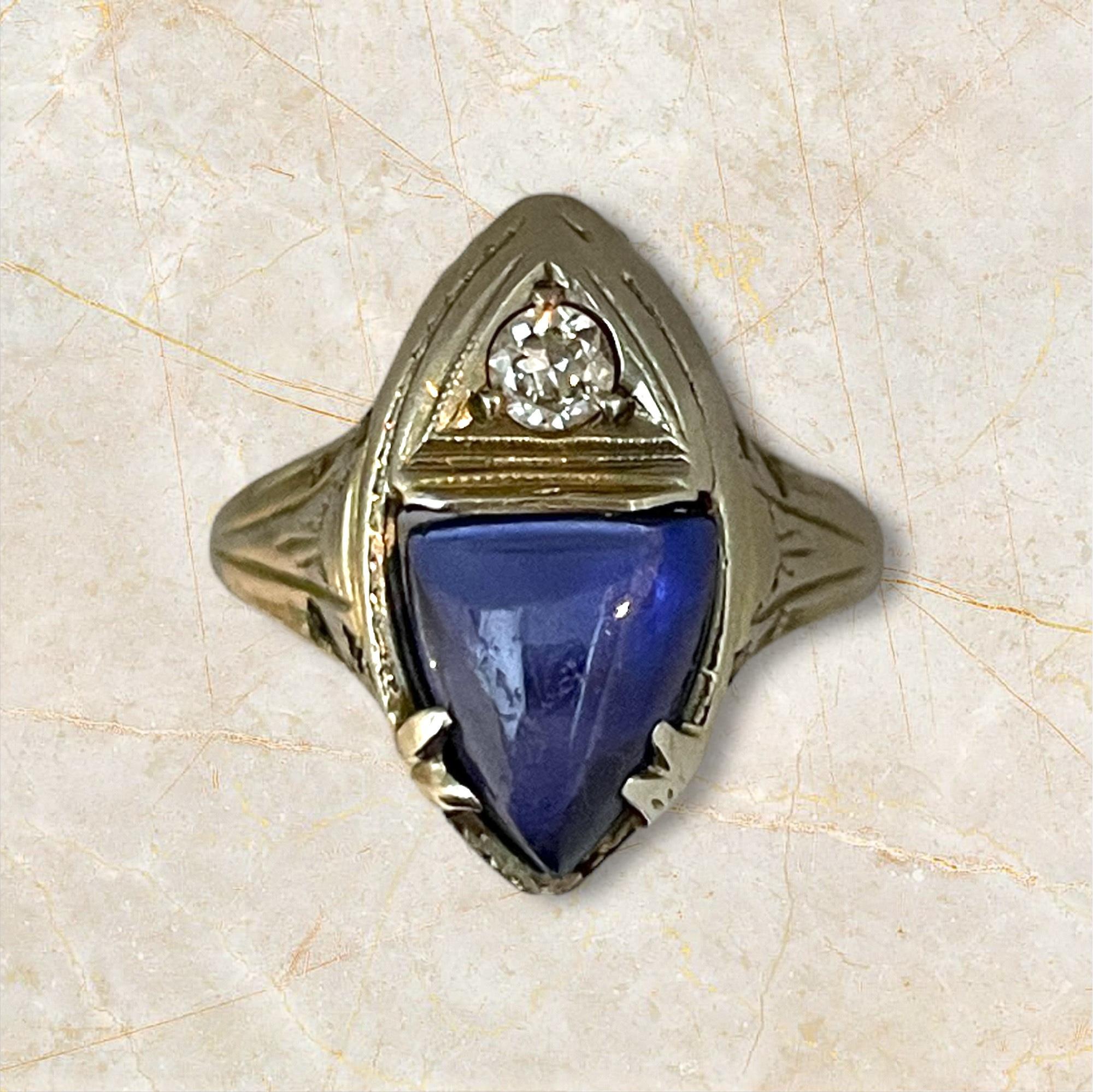 This exquisite ring features a striking marquise-cut sapphire set in 18K white gold, crowned with a sparkling diamond accent. The deep blue hue of the sapphire contrasts beautifully with the brilliance of the diamond, creating a timeless piece