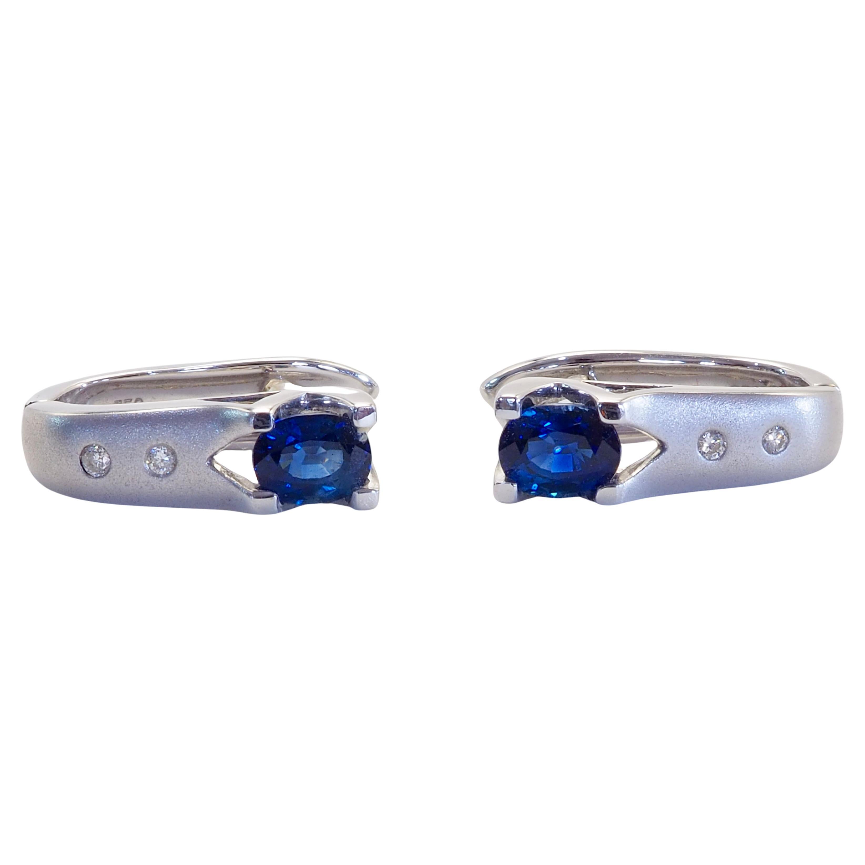 Beautiful latch-back earrings with 2 oval blue sapphires set inside and 4 total diamonds of brilliant color and shine set nicely up on the matted white gold finish. Quality craftsmanship met with quality natural and good colored gemstones. Perfect