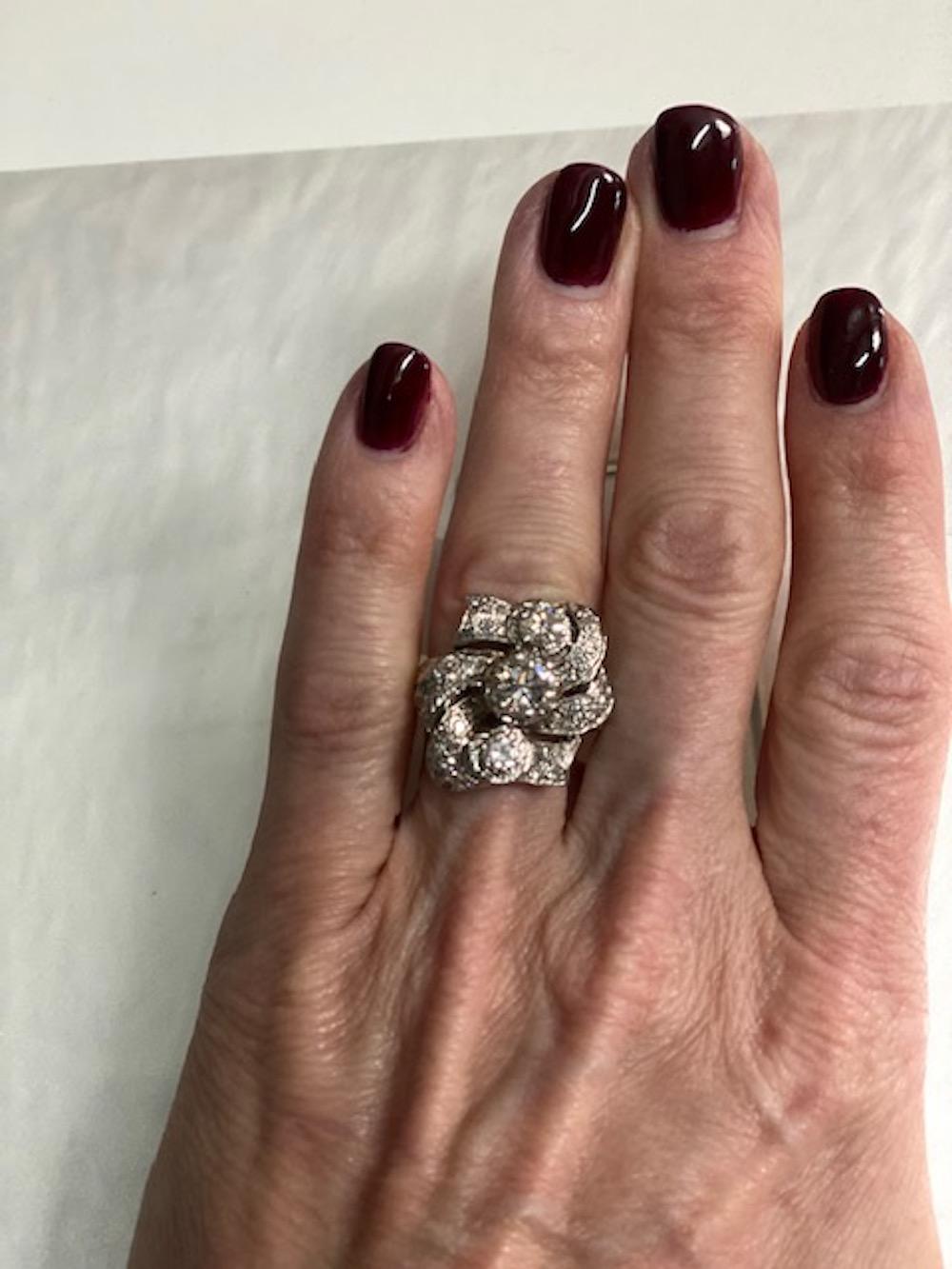 Rare and classic 18K White Gold Old Mine Cut Diamond Ring. This ring embodies class and elegance; with approximately 3.5 carats of mine cut diamonds.  This ring has a center stone that is 6.6 mm, as well as a top and bottom set diamonds that are