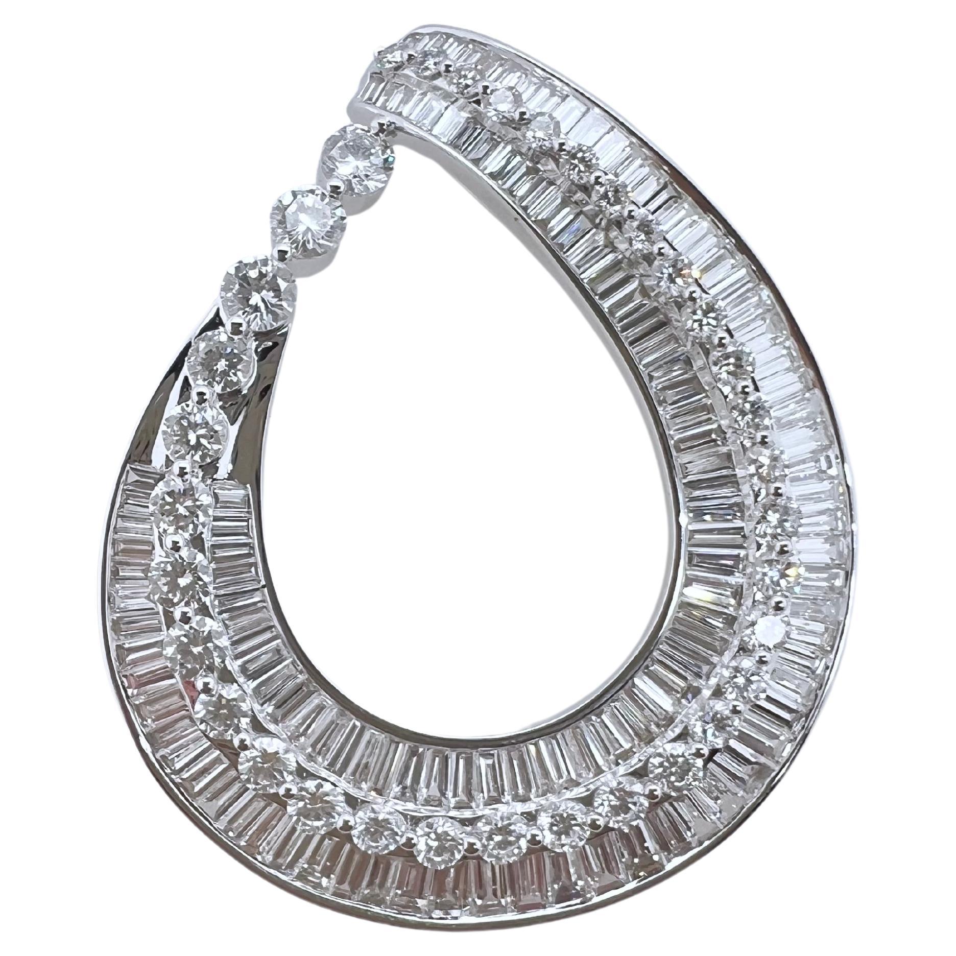 This 18k white gold tear drop shaped diamond baguette and round brilliant is absolutely stunning! The baguettes are channeled set while the round brilliant diamonds are strategically placed like a line on top of the baguettes. Extremely difficult to