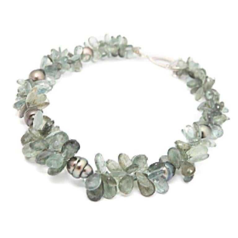 The cool and clear look of this necklace lends well to any occasion and wardrobe selection. Faceted from moss aquamarine briolettes with baroque Tahitian pearls at intervals, this refined necklace comes together with an 18k white gold toggle clasp