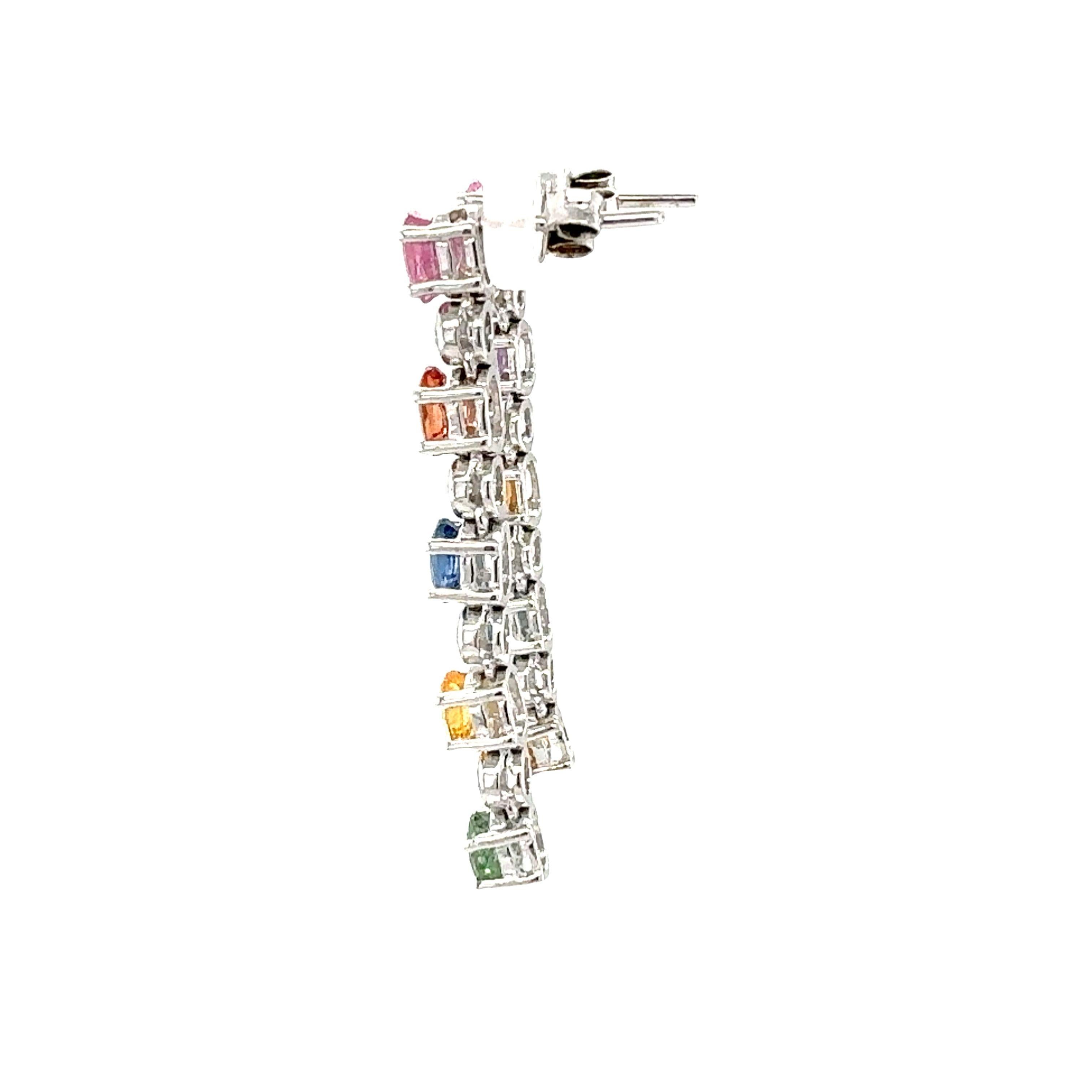 This stunning pair of 18K white gold earrings brings together a playful array of multi-colored sapphires and the timeless sparkle of diamonds. Each earring features ten prong-set sapphires totaling 4.50 carats in an enchanting mix of colors,