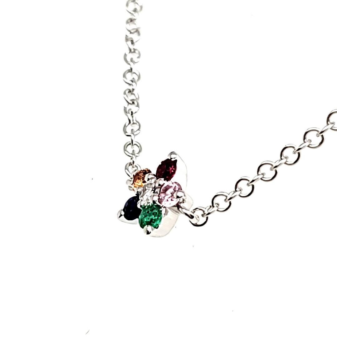 Featuring stones as vibrant as flowers, it boasts five mesmerizing multi-stones—Emerald, Blue Sapphire, Pink Sapphire, Orange Sapphire, & Ruby—delicately arranged as petals around a sparkling 0.02 cts of a round diamond center, totaling 0.12