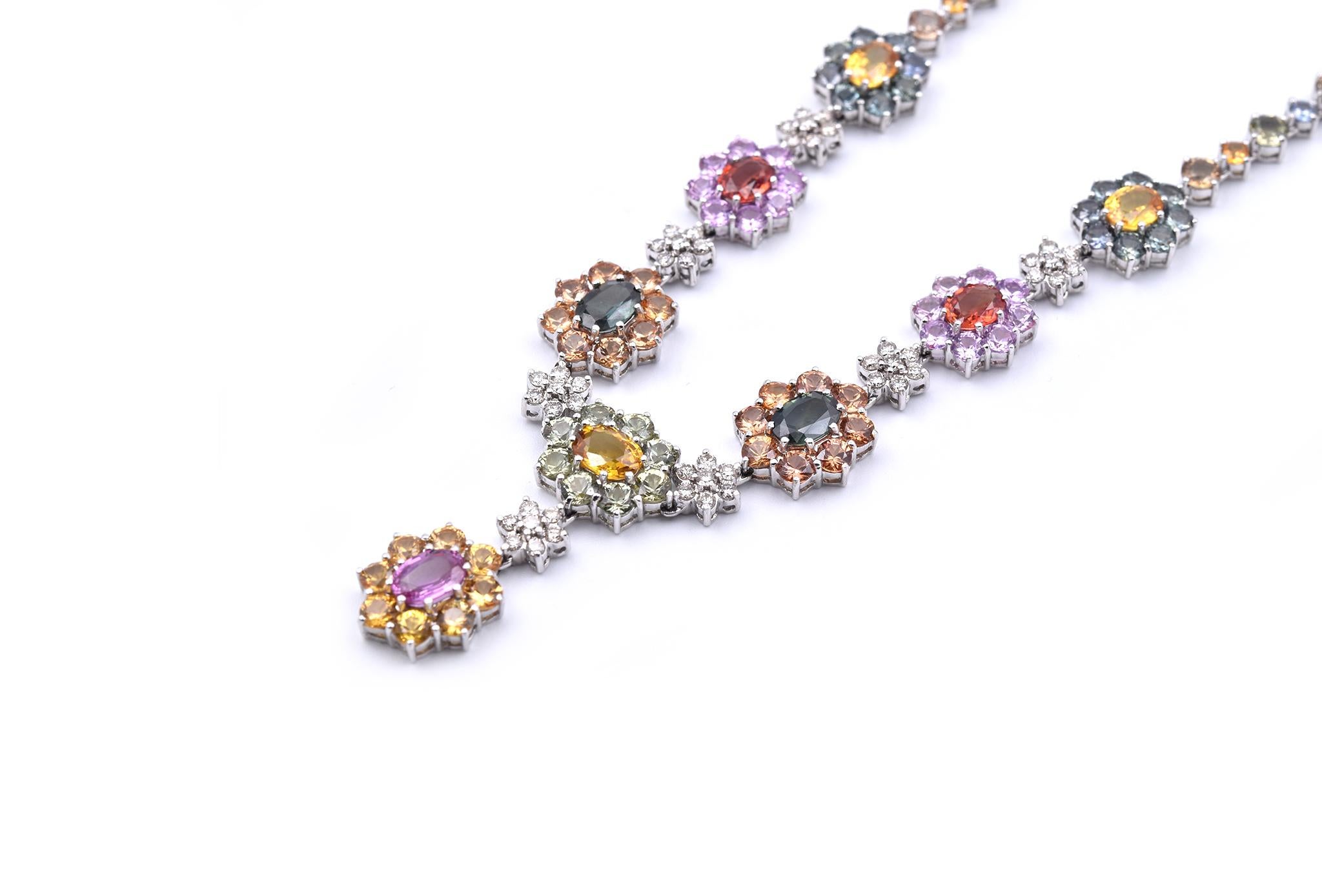 Designer: custom designed
Material: 18k white gold
Sapphires: round and oval cuts, turquoise, pink, red, orange, green, and yellow sapphires
Diamonds: 49 round brilliant cuts = 1.00cttw
Color: I-J
Clarity: VS2
Dimensions: necklace measures 15-inches