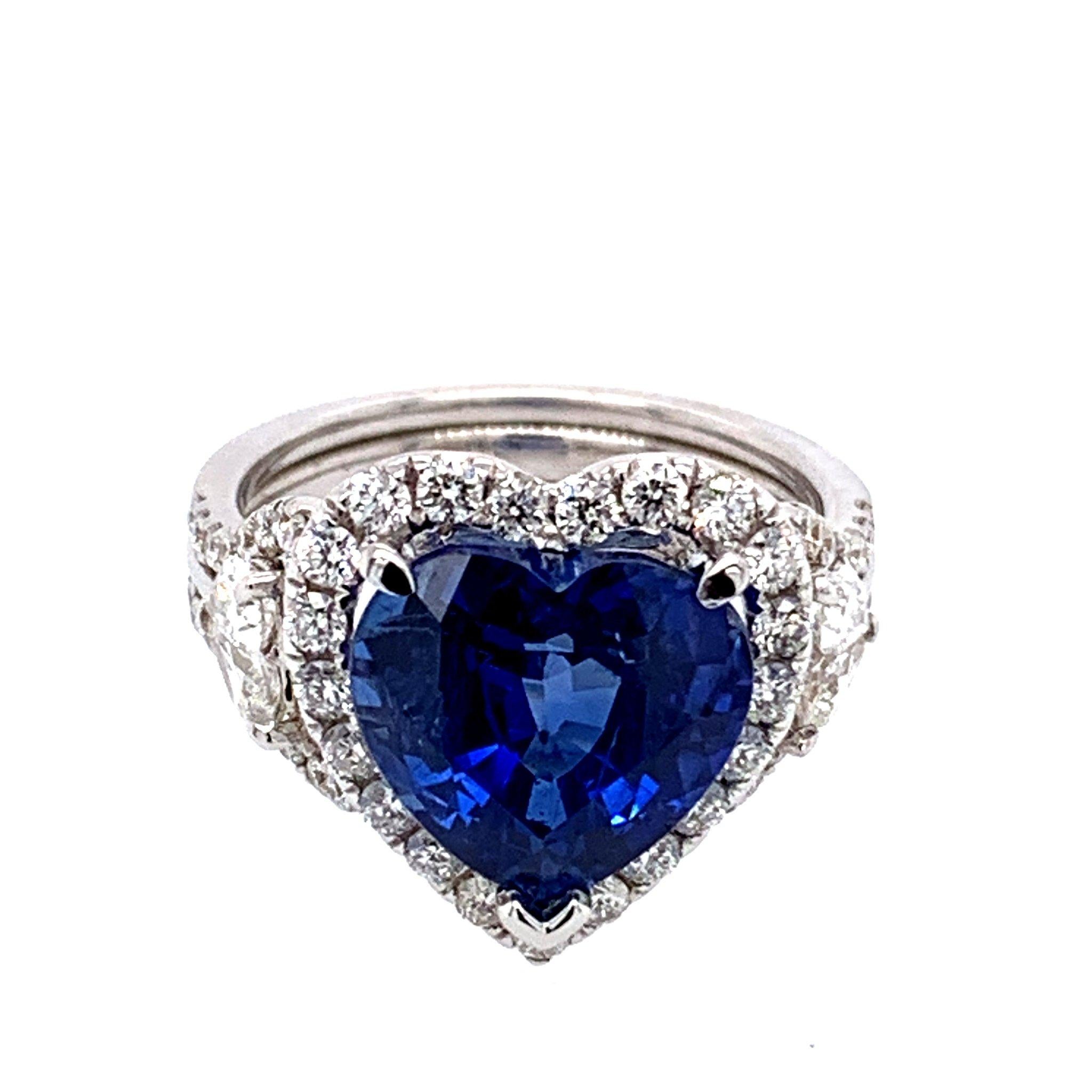 Celebrate your love with this unique, heart shaped blue sapphire and diamond Art Deco style ring. Blue heart shape natural Sapphire center stone is weighting 5.44 carat. Surrounded with 1.30 carat of white diamonds. The ring is crafted in 18k white