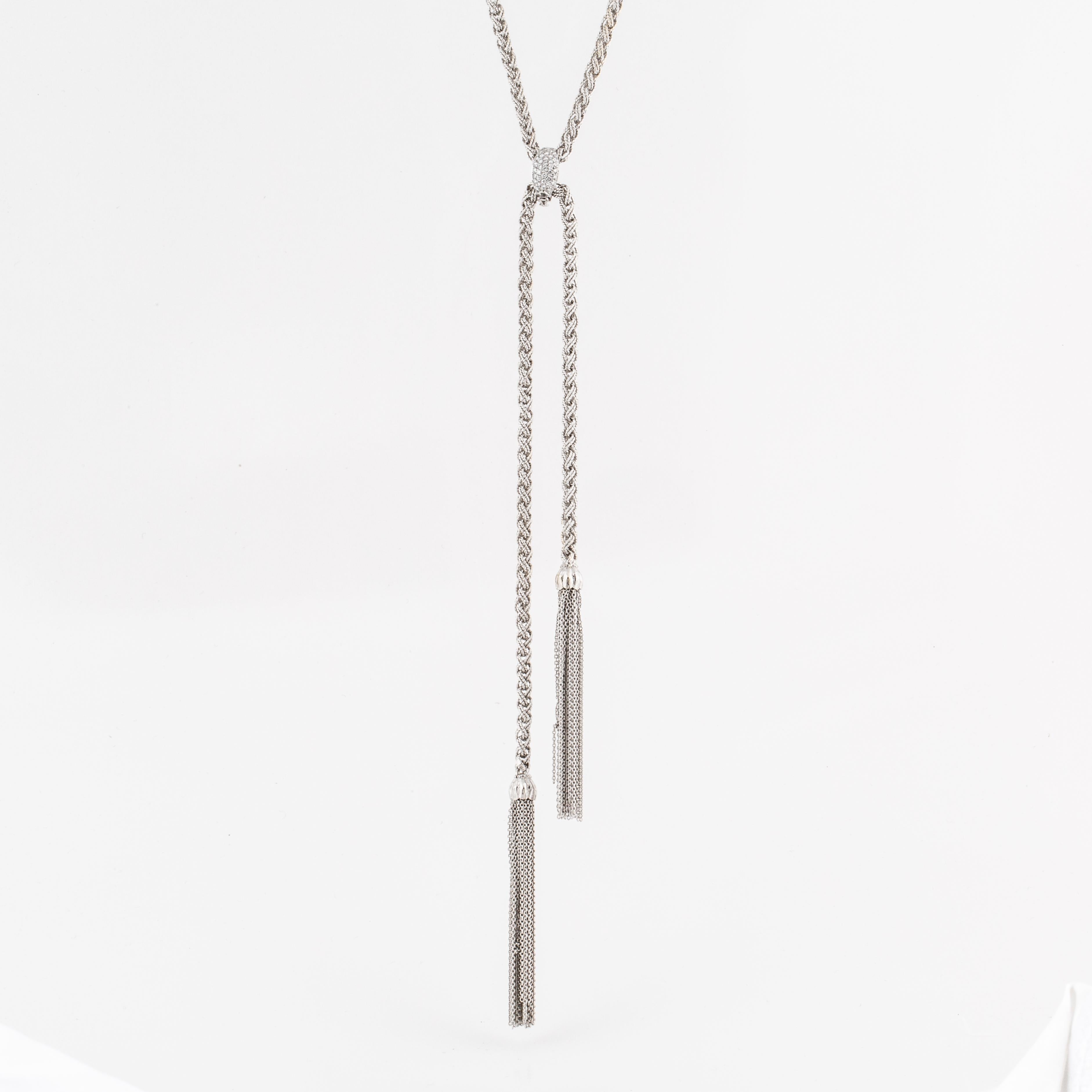 Necklace composed of 18K white gold.  There are removable tassels as well as two clasps; one accented by round diamonds and the other with a satin finish.  The diamond clasp contains 33 round diamonds with a total carat weight of 0.65.  The necklace
