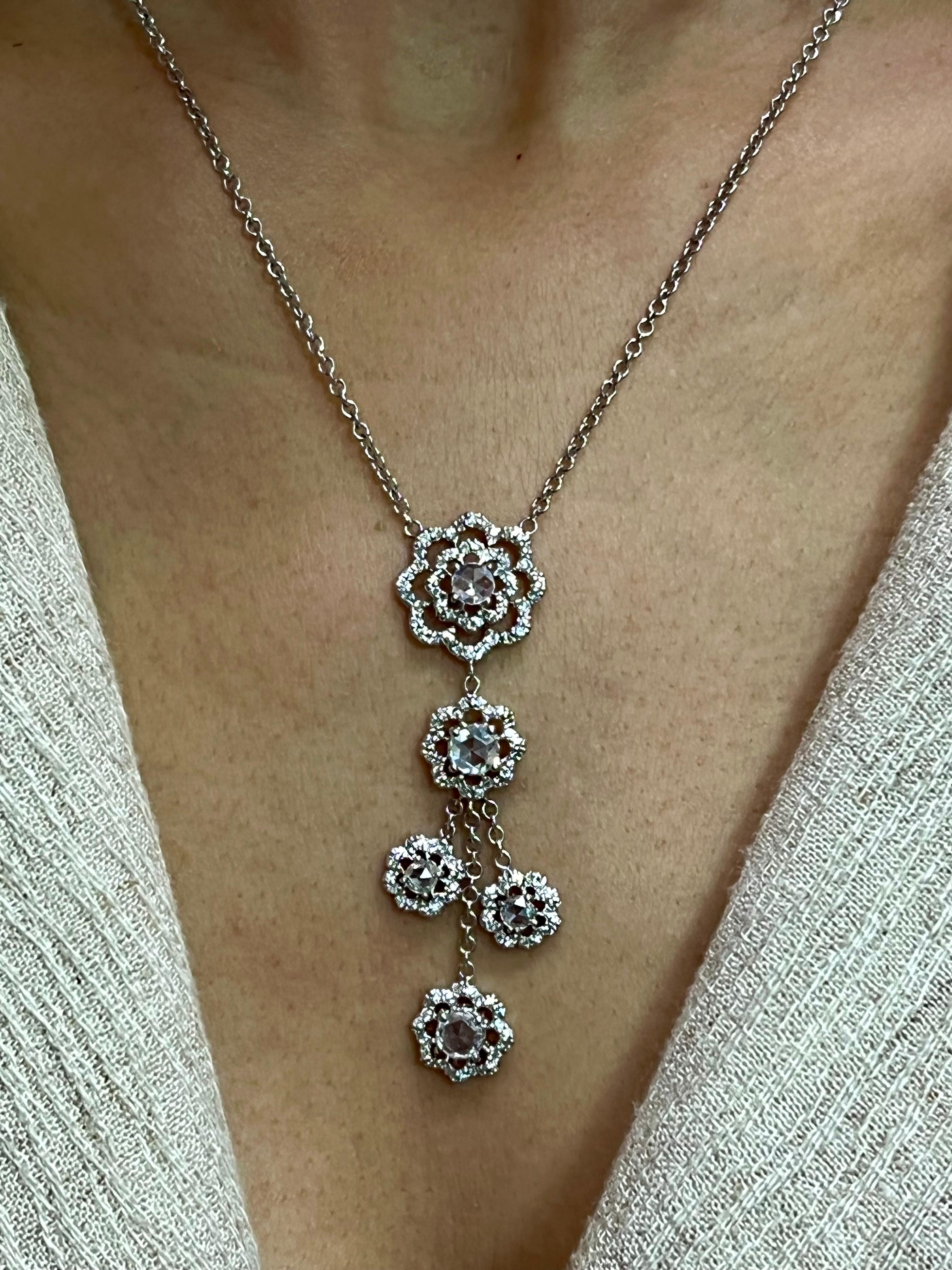 Please check out the HD video!  The pendant is set in 18k white gold with new rose cut and round brilliant cut diamonds. There are 5 larger new rose cut diamonds totaling 1.24cts and 128 round brilliant diamonds 0.64cts. All in all a total of