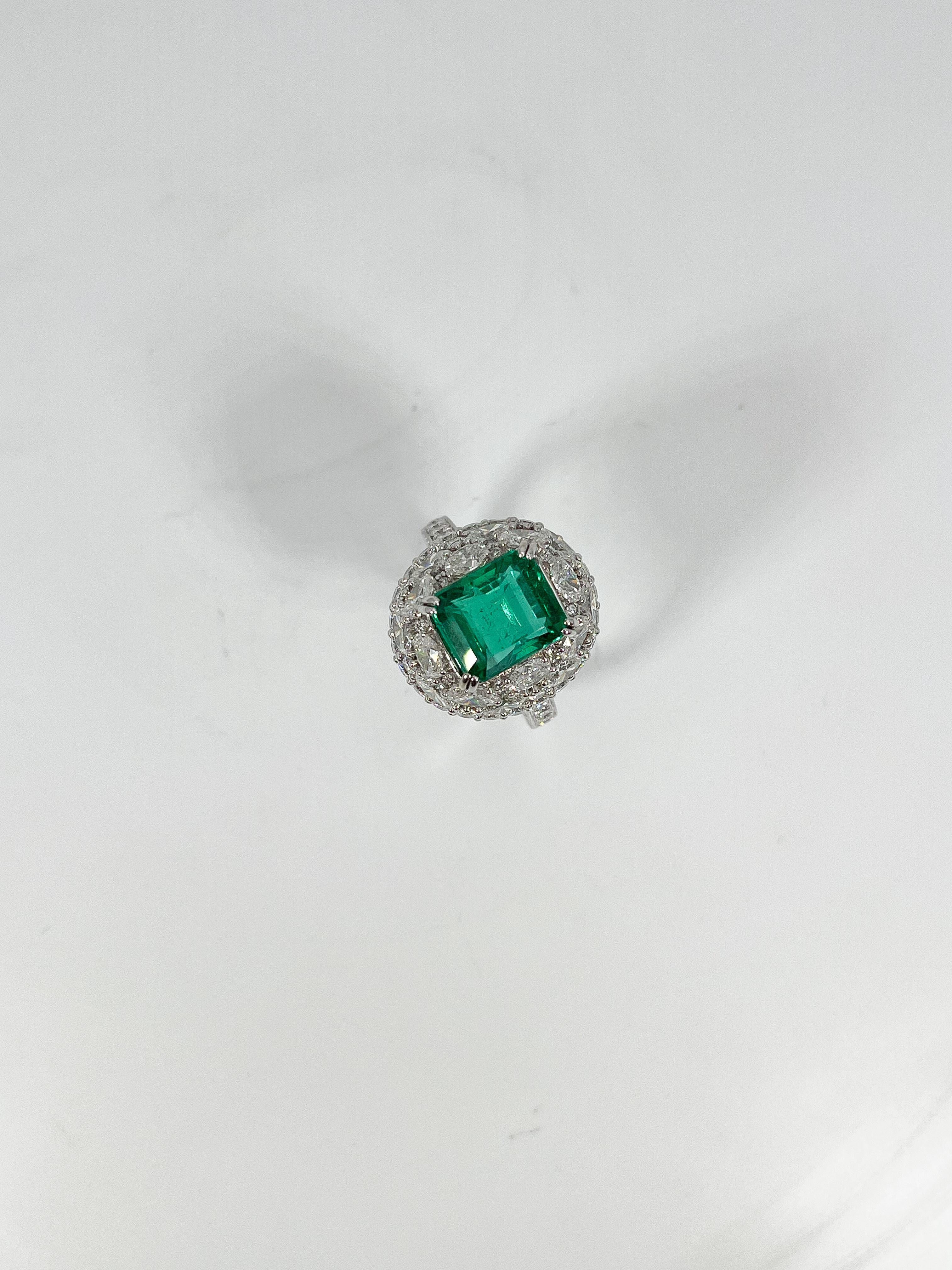 Ladies 18k white gold size 7 1/2 ring prong set with an octagon step cut emerald and oval and round brilliant cut diamonds. Total item weight is 10.8 grams. Comes with AJI certification. 
Emerald Attributes: 
Shape and Cut- Octagon step