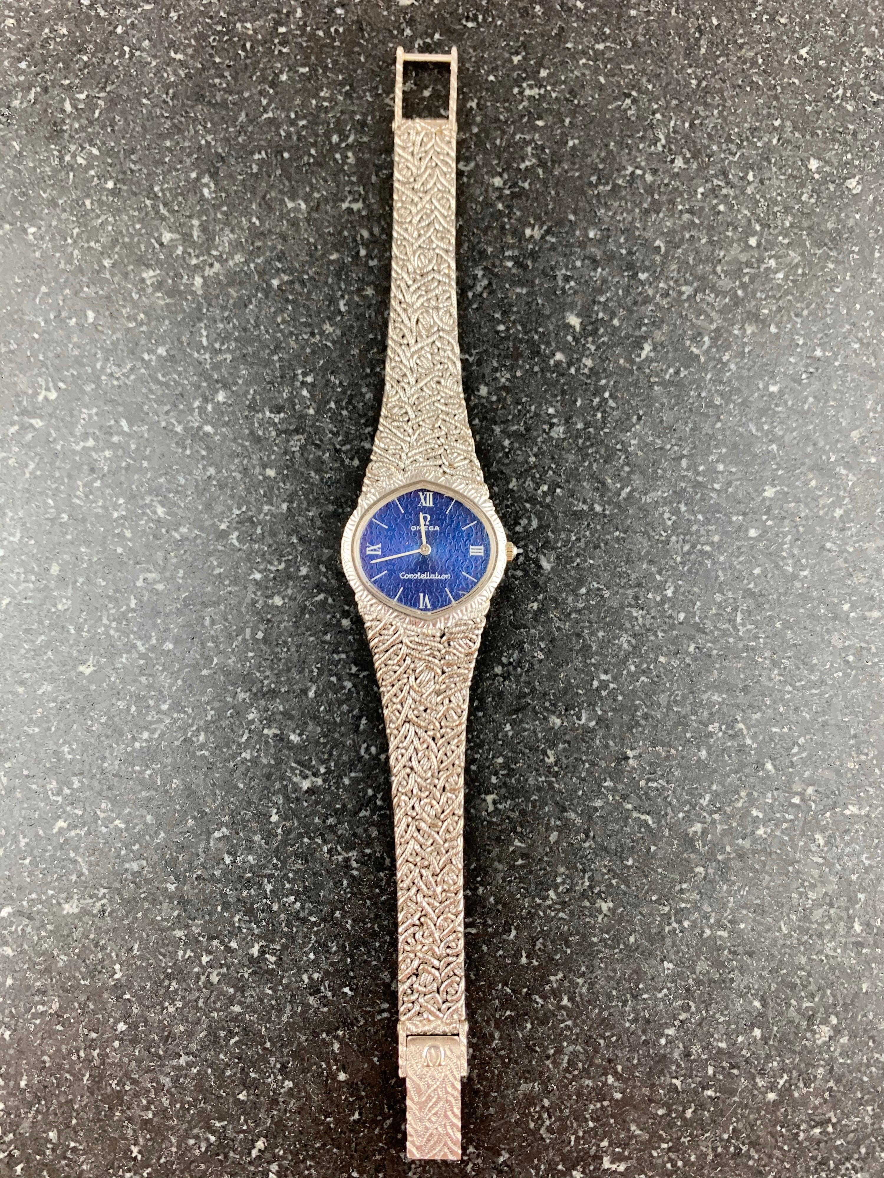 18K White Gold Omega Constellation Ladies Bracelet Dress Watch. 
The Watch Has A Lapis Blue Dial Lazuli Dial With Almond Shaped Bezel. 
18 Carat White Gold (52 Grams) Case With Integrated Entwined Woven White Gold Omega Bracelet. The Detailed Crown