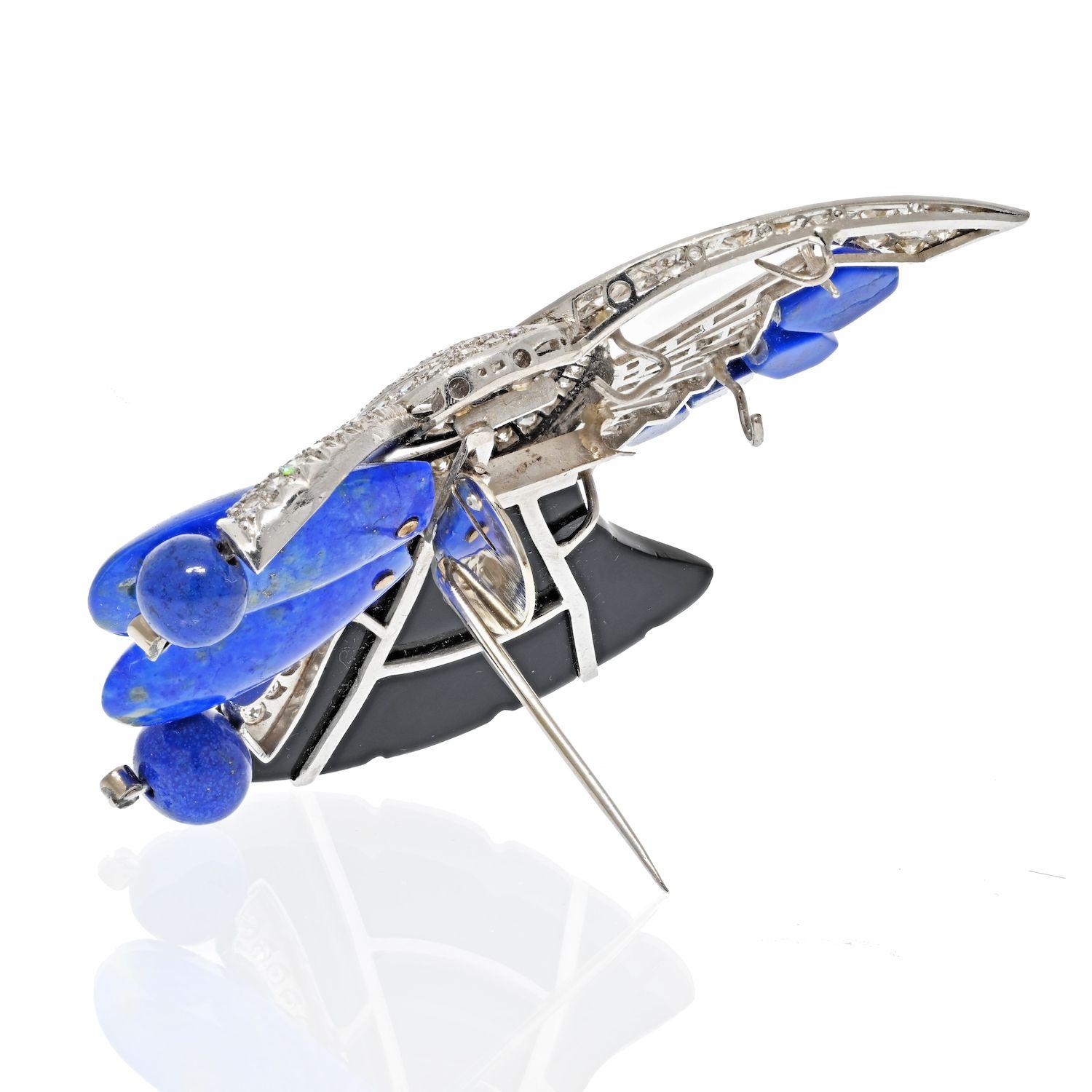 A beautiful pin from 1980's made in 18K White Gold with black onyx, blue lapis and round diamonds.Presenting outstanding craftsmanship and top-quality gems in a heavenly set design with a playful display of life and color. This pin comes with a