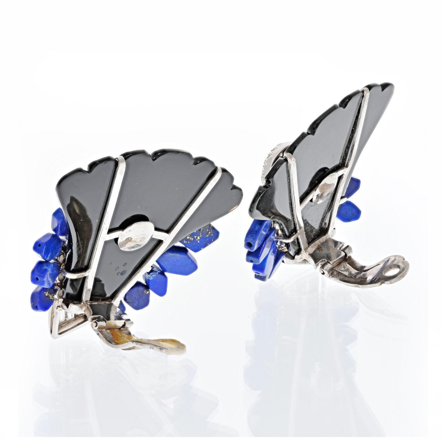 A true represantion of 1980's jewelry is this bold pair of clip earrings crafted in 18k white gold, set with diamonds, lapis lazuli and polished onyx. 
Resemblong a fancy spray these fun earrings are sure to be your conversation piece every time you