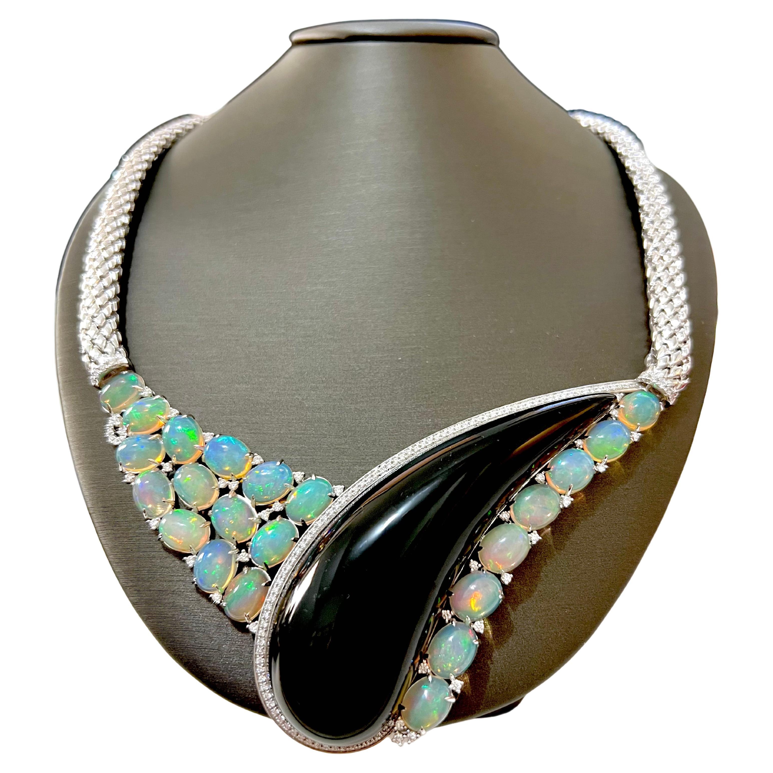 This Art-Deco style Ethiopian Opal necklace is handmade with custom cut onyx and diamonds.  The opals are strategically placed throughout the necklace to accentuate the elongated tear drop onyx.  The diamonds are sprinkled throughout and tastefully