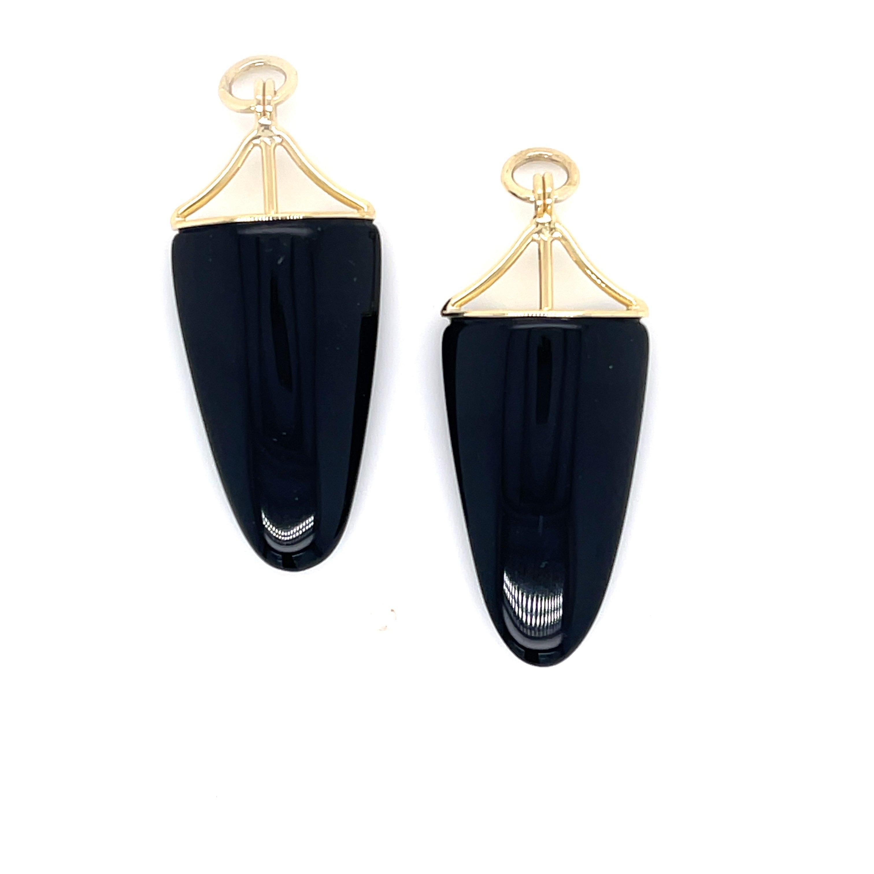 A pair of 18k white gold earring studs martini head set with 8mm round faceted onyx, with a pair of 18k yellow gold jackets set with two long bullet shaped onyx. These earrings were made an designed by llyn strong.

Items sold separately upon