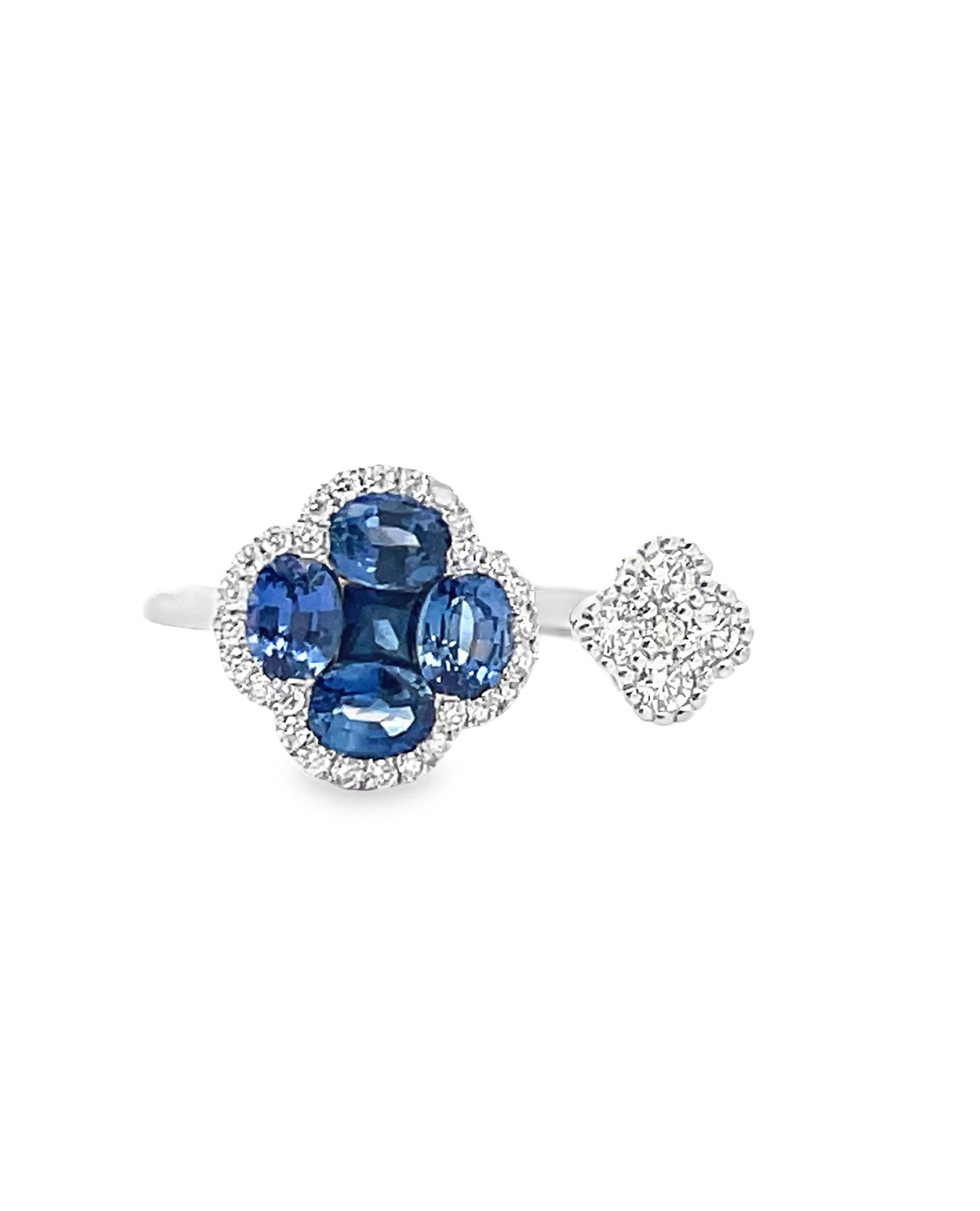 18K white gold open bypass quatrefoil ring with round faceted diamonds weighing 0.21 carat total and sapphires weighing 1.25 carats total. 

- Finger size 6.5