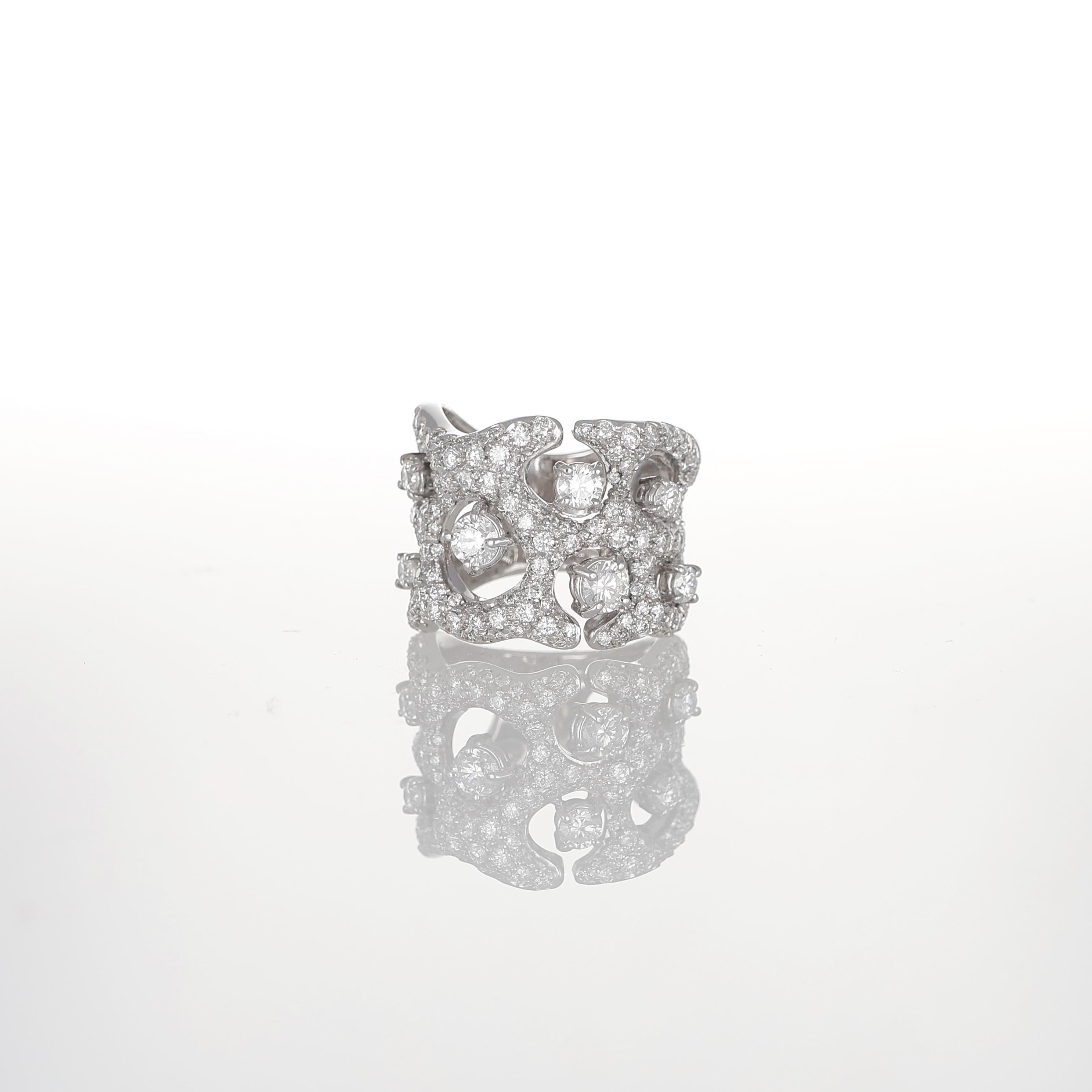 An elegant fusion of structure and brilliance, this 18K white gold ring showcases an intricate openwork design adorned with a pavé of brilliant-cut diamonds. The bold yet refined silhouette is accentuated by seven individually set diamonds, totaling
