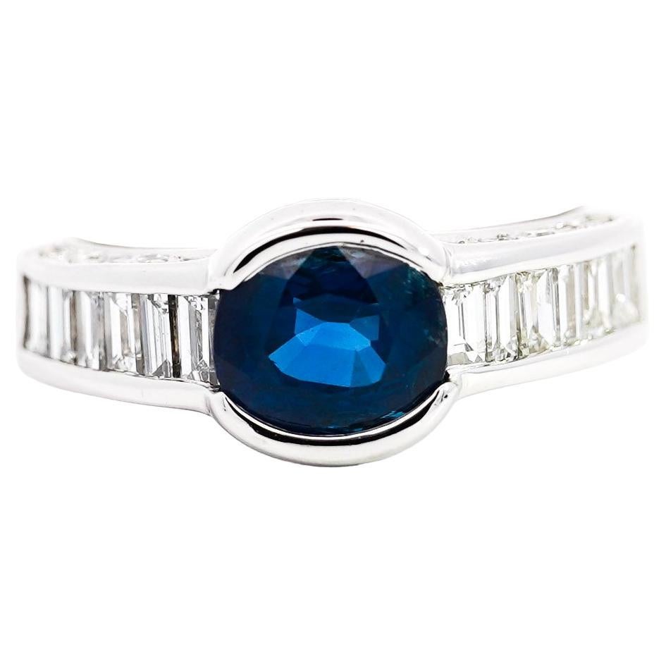 18K White Gold Oval Blue Sapphire & Baguette Diamond Channel and Bezel Set Ring For Sale