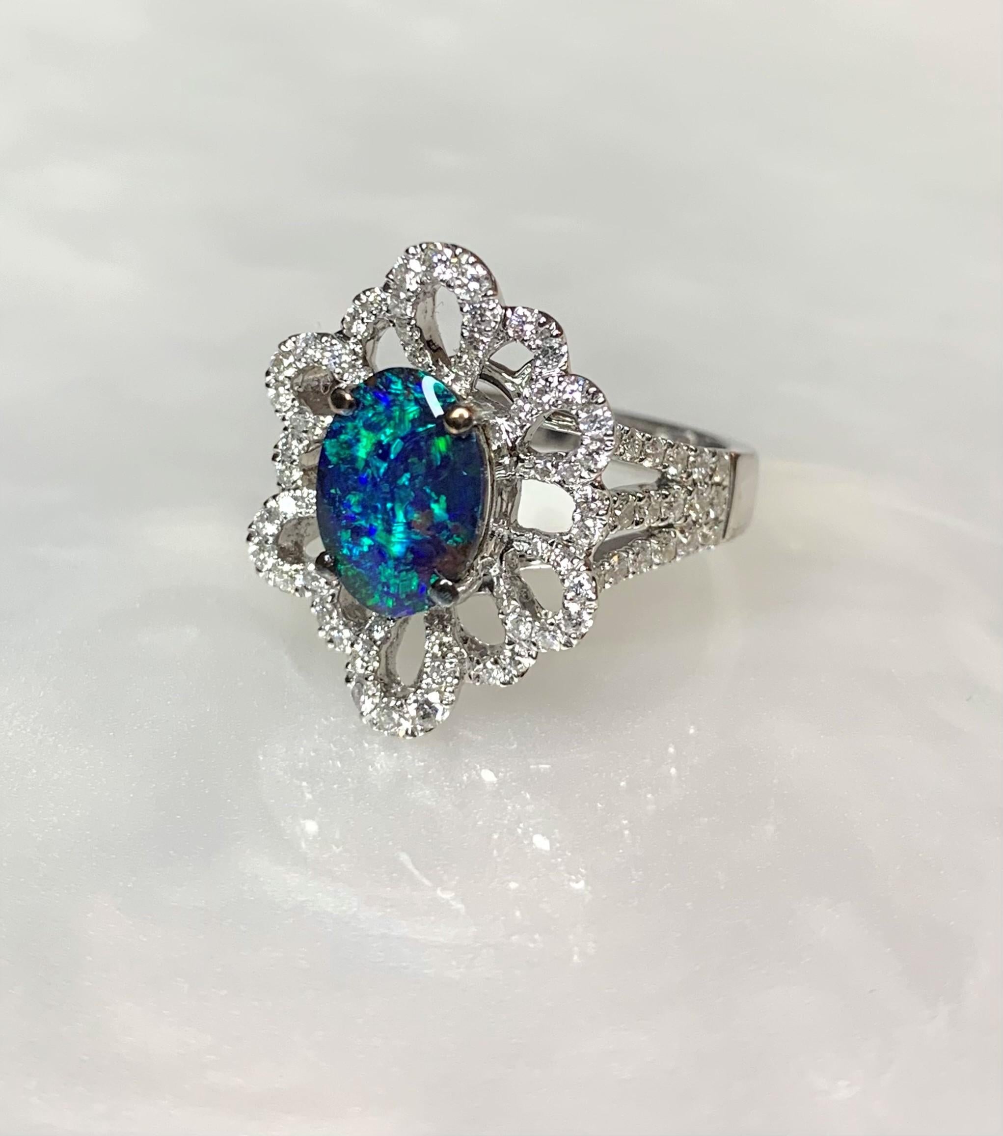 A phenomenal Australian black opal ring boasting a glowing blue-green oval center stone weighing 4.86 surrounded by exceptional sparkling white diamonds weighing 1.82 carats. Final call on this exquisite collector's dream.

*Approximate stone