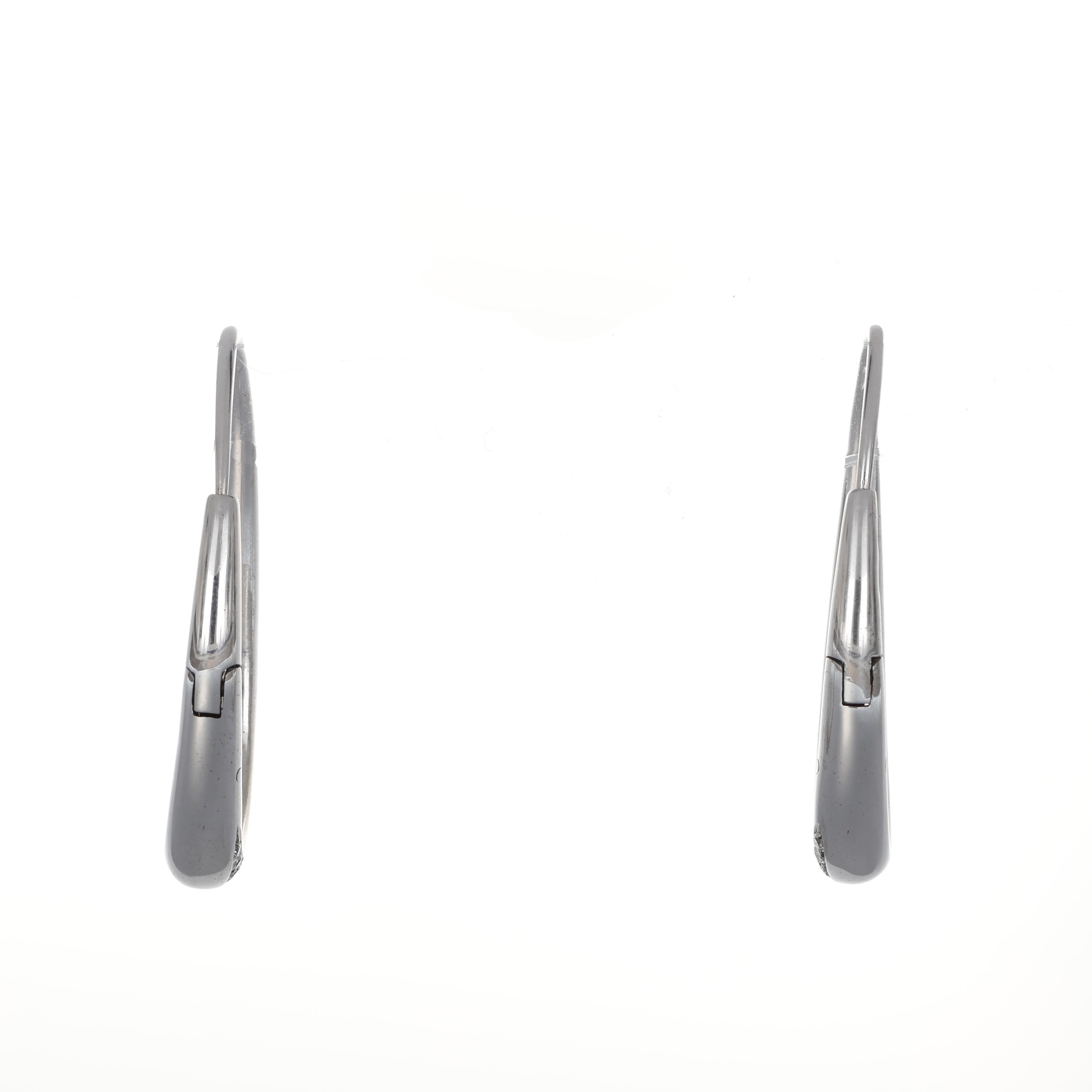 Refined and versatile, these 18K white gold oval hoop earrings feature a sleek, elongated silhouette that enhances their modern elegance. Adorned with a delicate pavé of brilliant-cut diamonds, they radiate a sophisticated brilliance, making them an