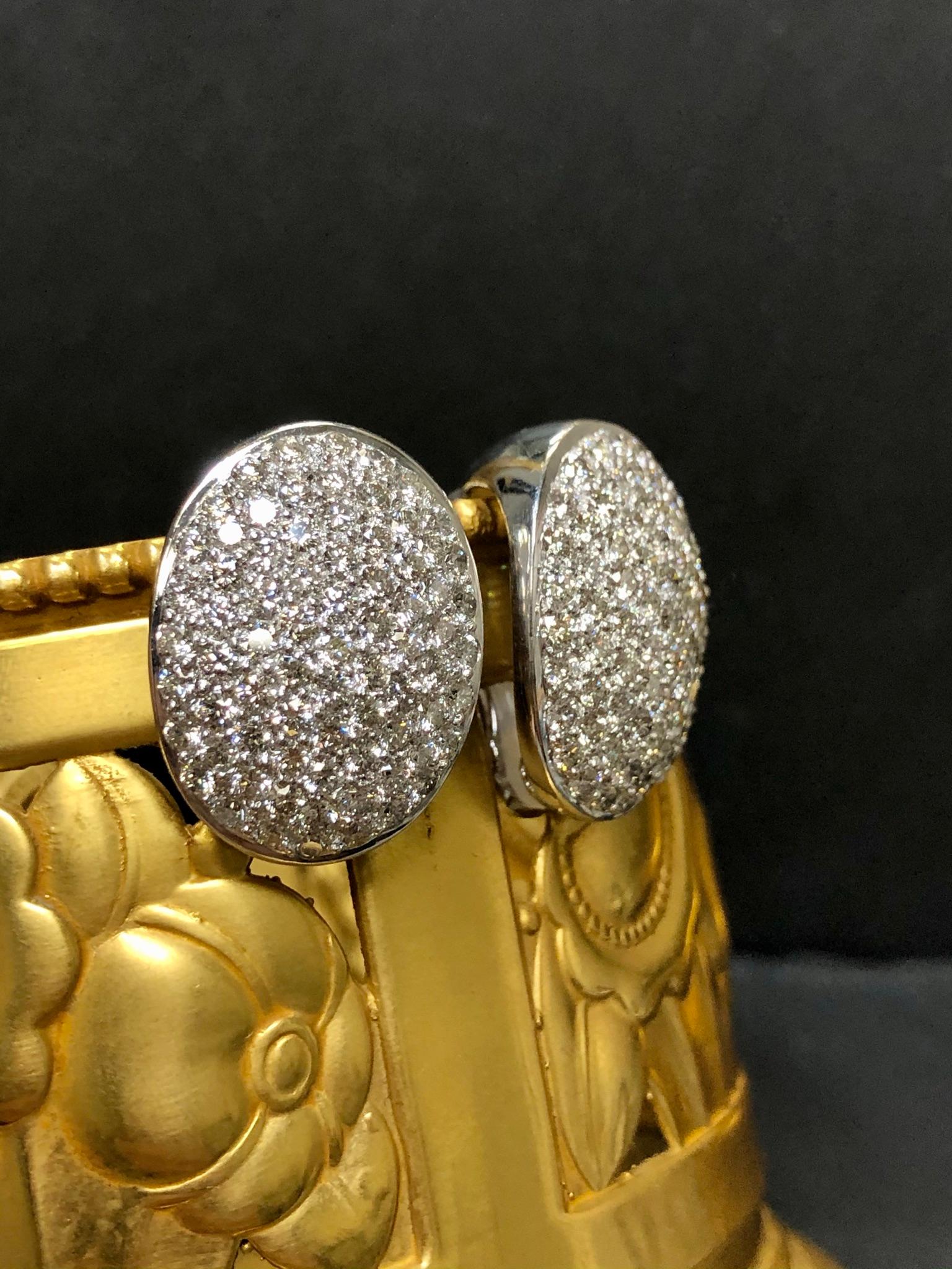 Contemporary 18k White Gold Oval Pave Diamond Omega Back Diamond Huggie Earrings H Vs 5cttw For Sale