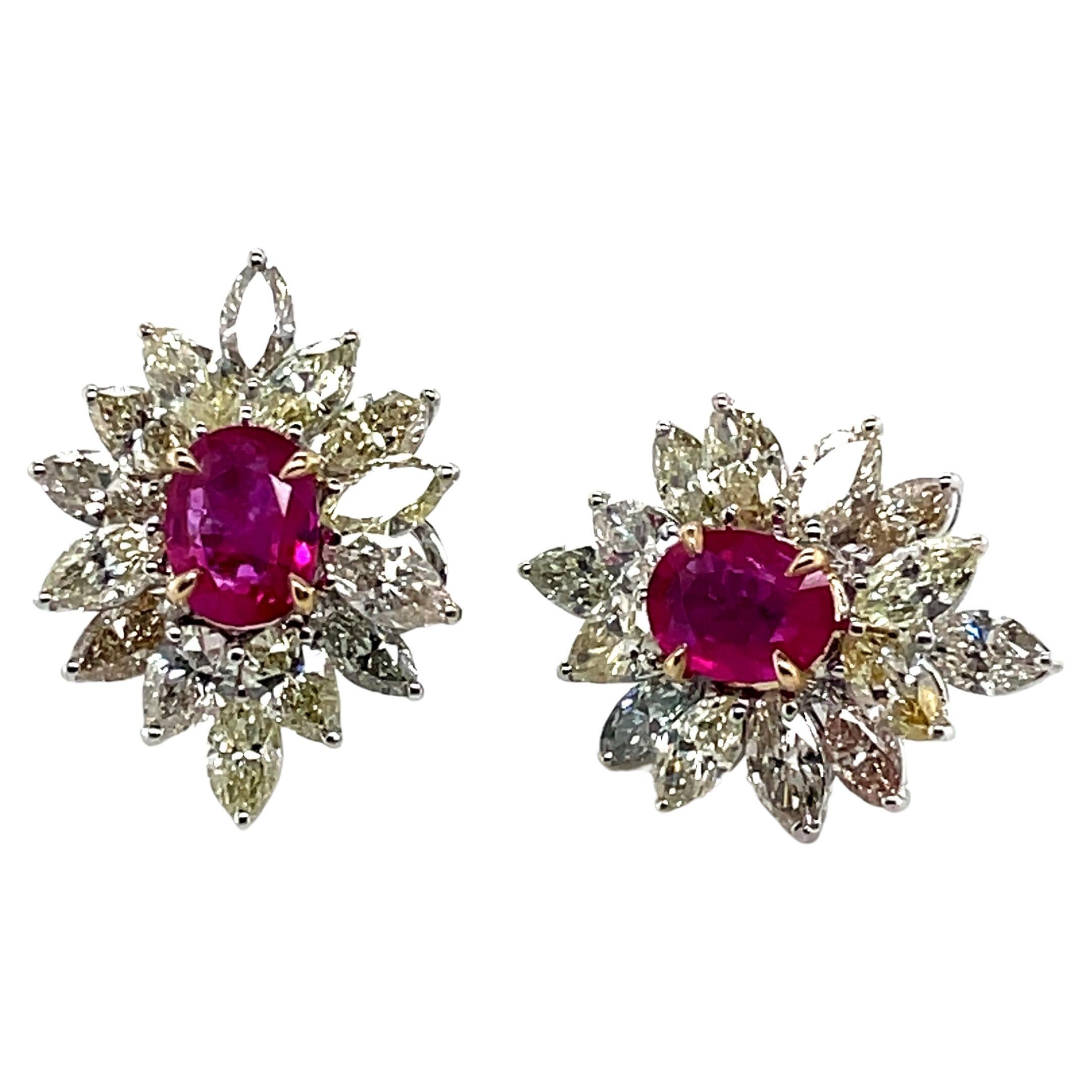 A radiant fusion of passion and sophistication. 

Featuring two exquisite oval rubies (1.65 cts) with an outstandingly rich and vivid red color from the legendary mines of Old Burma.

The rubies are surrounded by a dazzling arrangement of 16 yellow