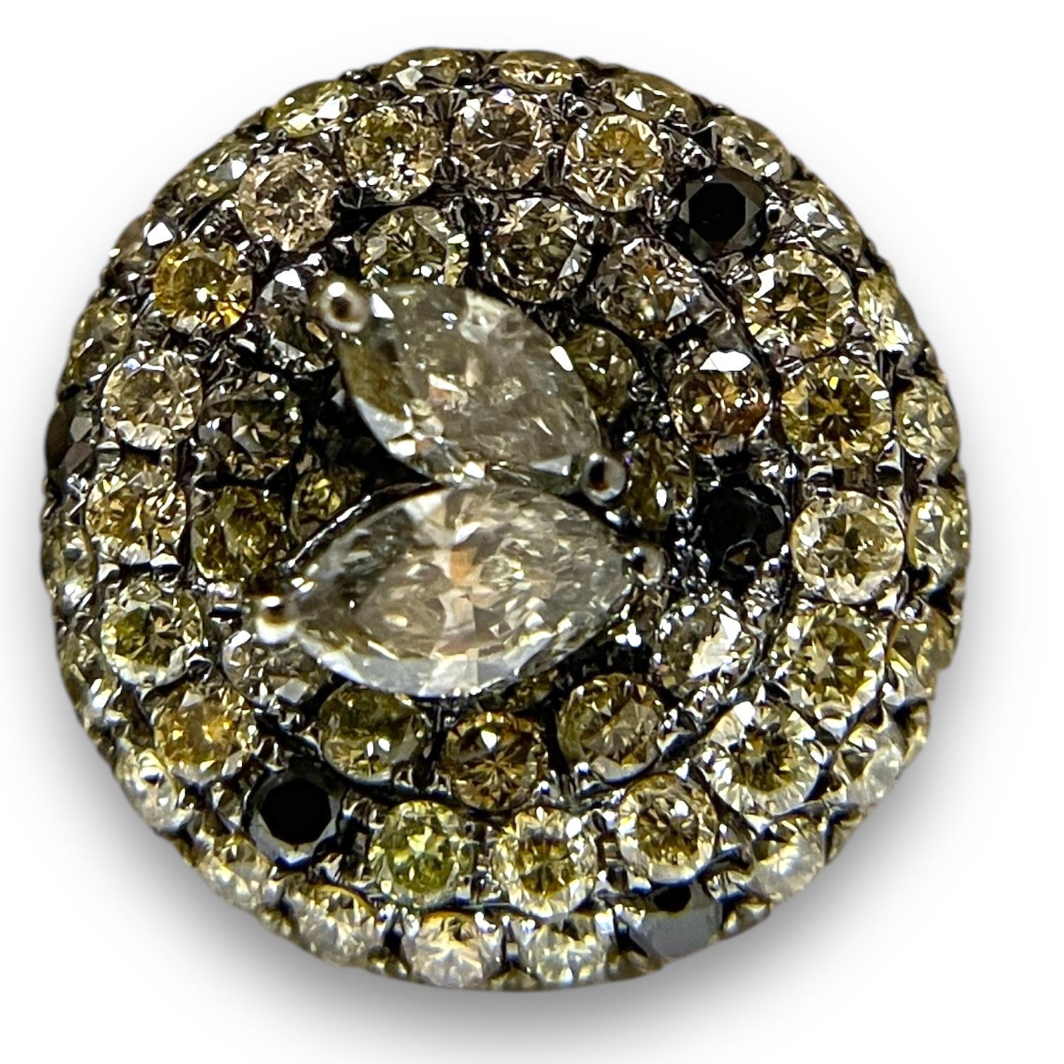 This striking 18K white gold cuff ring showcases an opulent pave setting of yellow, black, and white diamonds, arranged in concentric circles for a mesmerizing effect. At the center, marquise-cut and round diamonds add a touch of elegance and