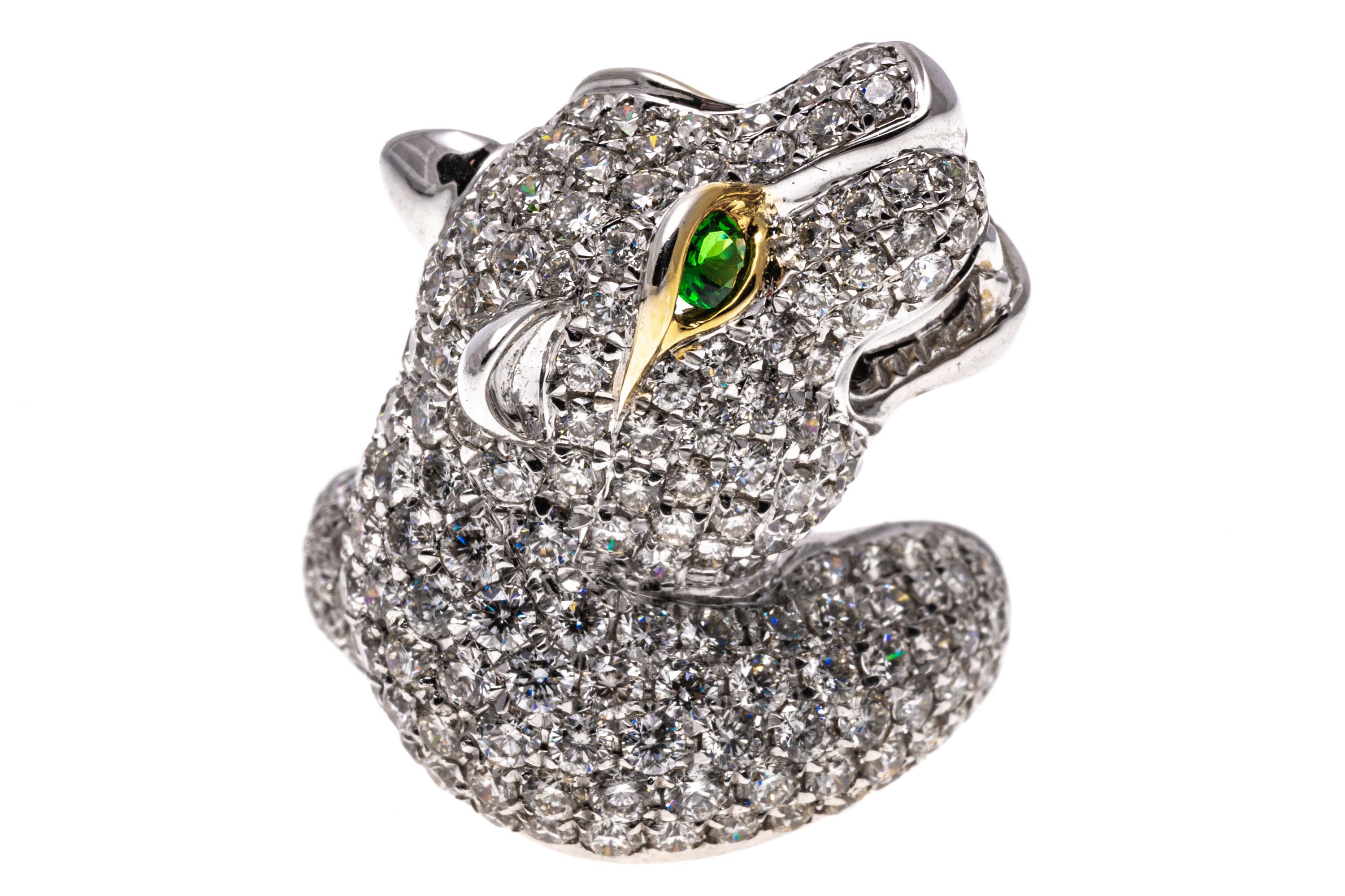 18k white gold ring. This gorgeous ring is a white gold, figural panther head motif, pave set with round faceted white diamonds, 2.76 TCW. The ring is finished by round faceted, bright green tsavorite garnet eyes, 0.26 TCW and a high polished