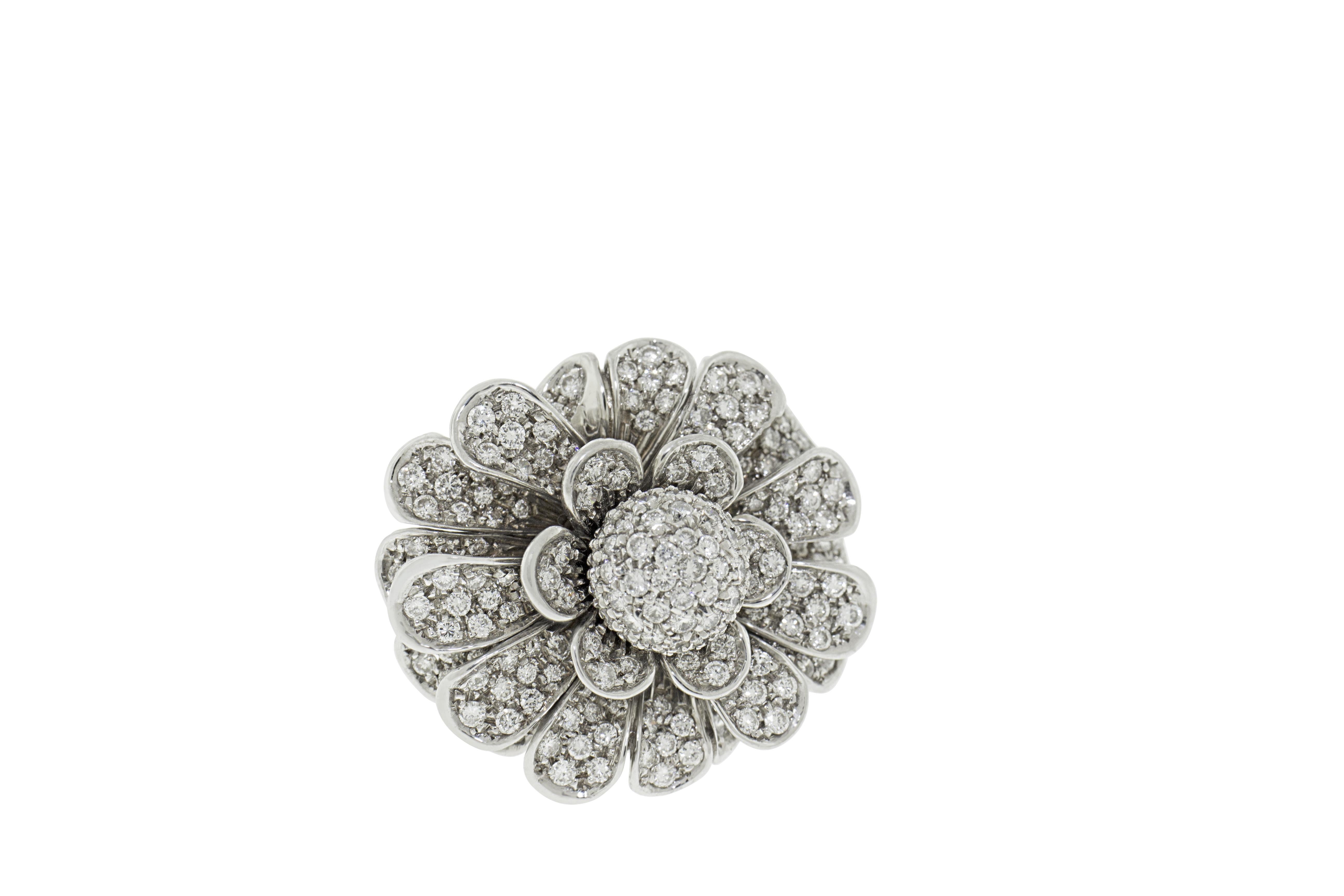 This ring features 3 carats of G VS pave diamonds set in 18K white gold. This intricate cocktail ring has unique floral petals that move mimicking a life like flower petal with each movement of the hand. Total weight 25 grams. Made in Italy. Size