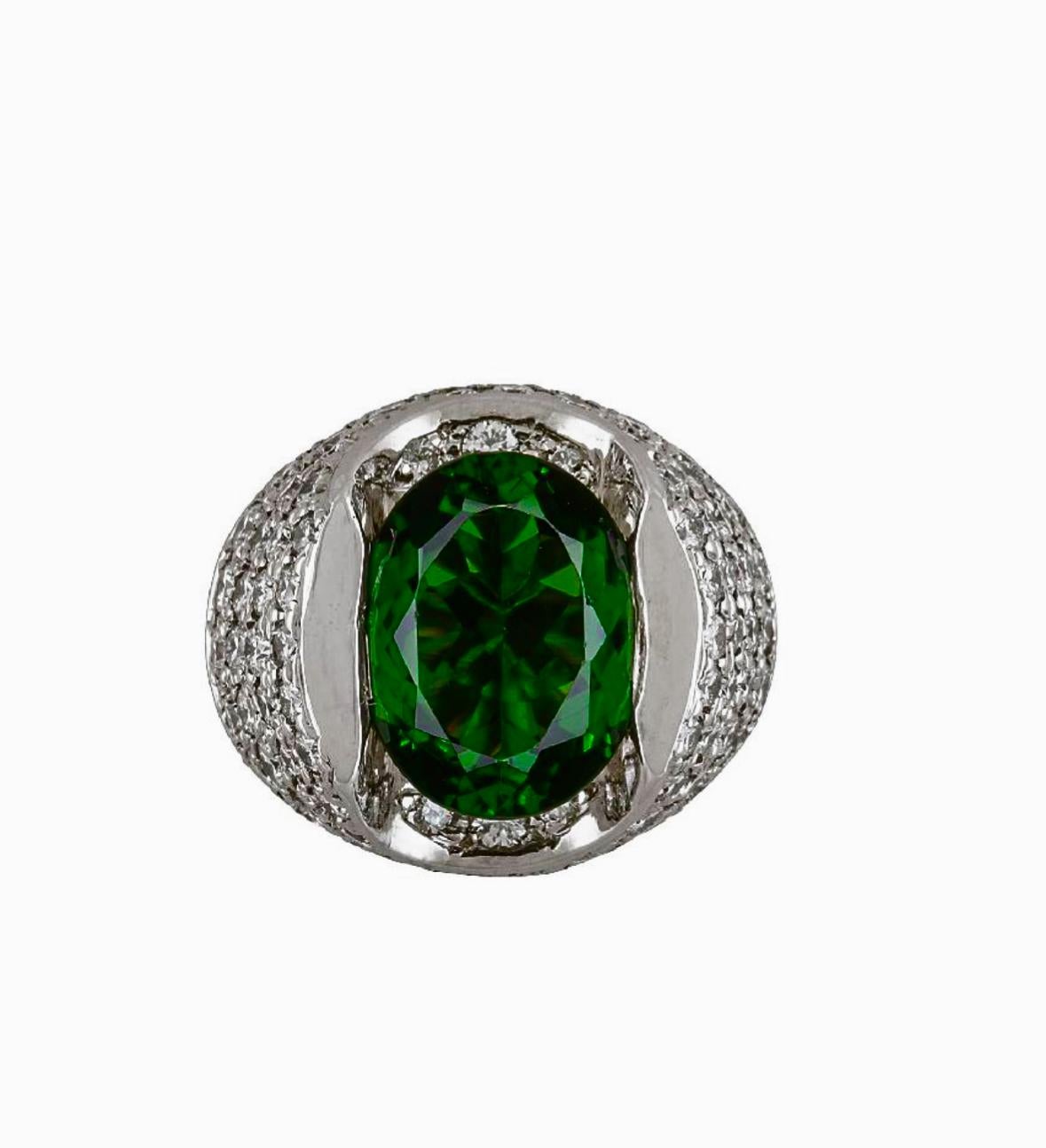 DeKara Design Collection 

Metal- 18K White Gold, .750.  21.50 Grams.

Stones- GIA Certified Oval Chrome Tourmaline 5.95 Carats.
74 Round Diamonds F-G Color VS2 Clarity 3.06 Carats.  

GIA Report Number 6237421656

Size- 6 3/4.  Free Sizing.  

A