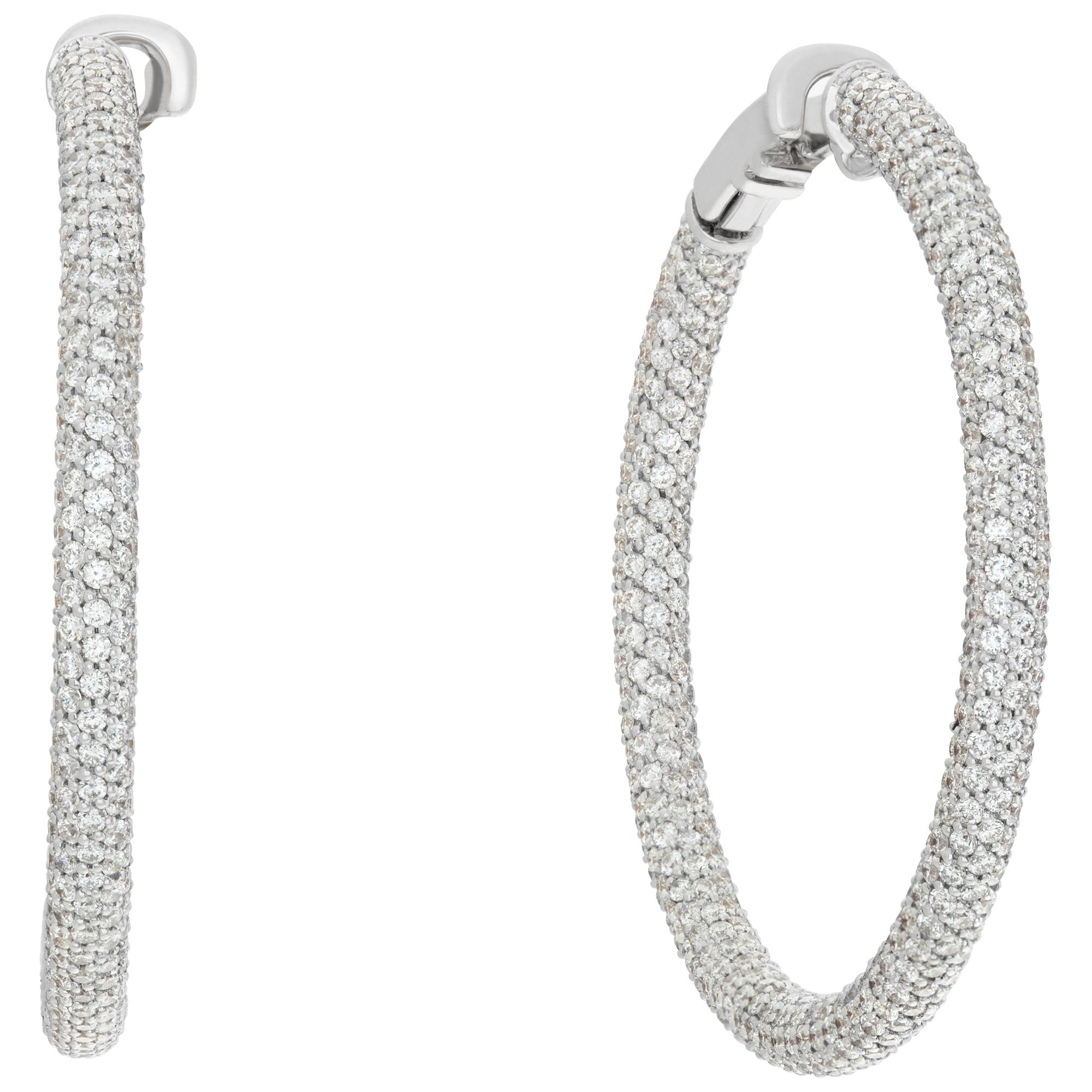Stunning 18k white gold pave diamond hoop earrings with 6.90 carats in round brilliant diamonds G-H Color, VVS Clarity. Hangs 1.6 inches, 3mm thick.
