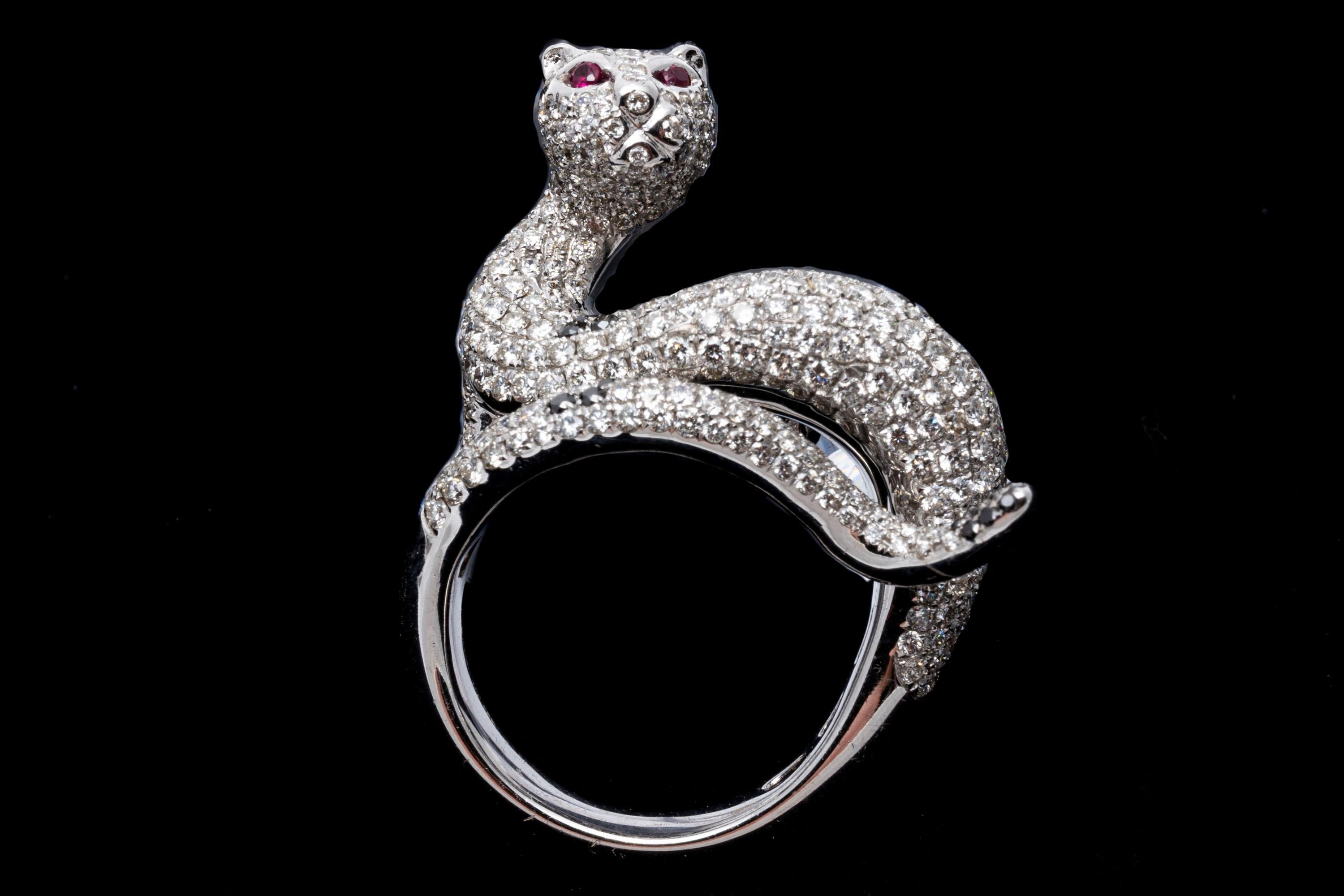 18k white gold ring. This stunning, elegant ring is a white gold, figural cat motif, with a slinky body and elongated tail bypass, pave set with round faceted white diamonds, approximately 1.54 TCW and decorated with black faceted diamonds spots,