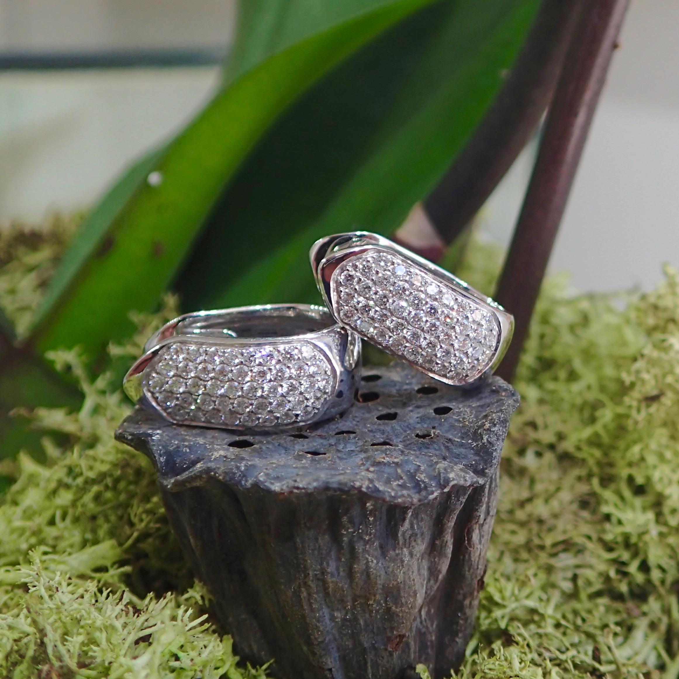 A pair of 18k white gold peak-top huggie earrings are set with eighty-eight (88) Round Brilliant Cut diamond weighing a total of 0.84 carats with Clarity Grade VS and Color Grade G. The earrings are 17.93mm tall and 7.30mm wide and weigh 8.7 grams