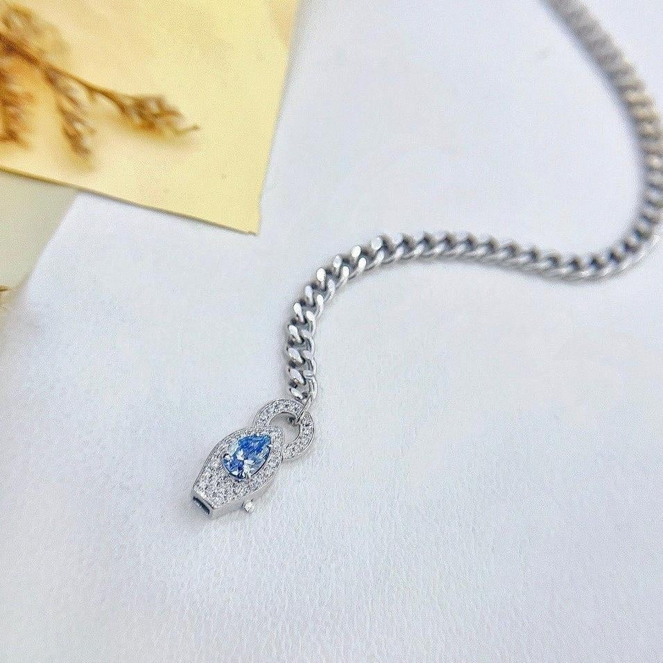 18K White Gold Pear-Cut Fancy Blue Diamond Cuban Chain Diamond Bracelet 

1 Fancy Blue Diamond - 0.24 CT
Diamonds - 0.12 CT
Total Weight - 4.14 GM

This exquisite bracelet is a true masterpiece, crafted with the utmost care and precision. Featuring