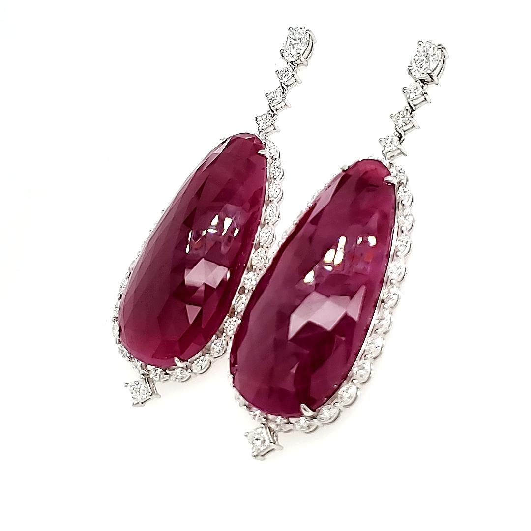At the apex, two oval diamonds totaling 1.10 cts illuminate the earlobe with their radiant brilliance, leading the eye down to the focal point: two pearl-shaped rubies weighing an astounding 107.34 cts each. 

They come from the famous mines of
