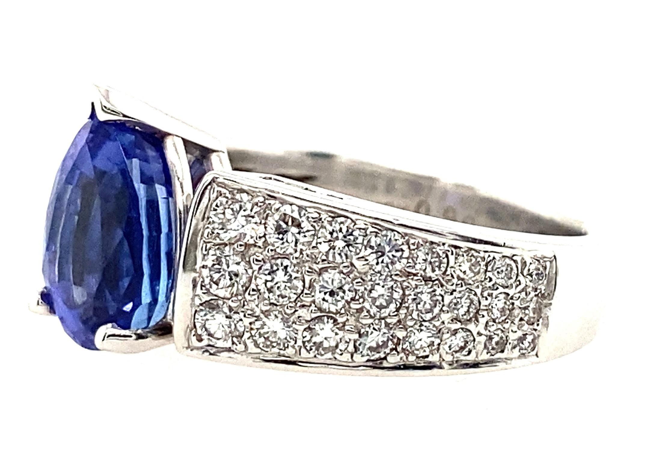 Every angle of this exceptional tanzanite ring is gorgeous, from the plush, saturated deep violet-blue of the 3.08ct tanzanite to the pave set diamond shoulders, to the gallery set with diamonds, to the open-work inside of the ring. The care of