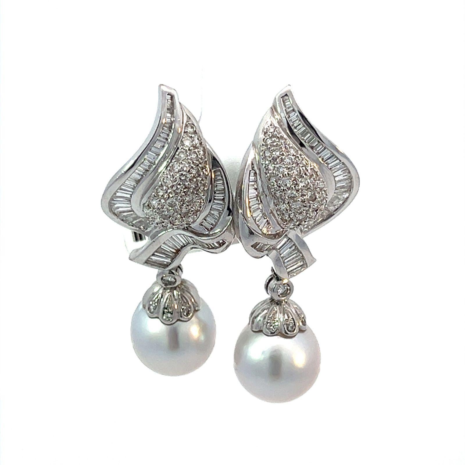 18k White Gold Pearl and Diamond Drop Earrings with 72 round brilliant and 88 baguette diamonds, totaling approximately 2.75 carats. The earrings can be worn with or without the bottom pearls attached. 
The removable, white lustrous, 12mm dangle