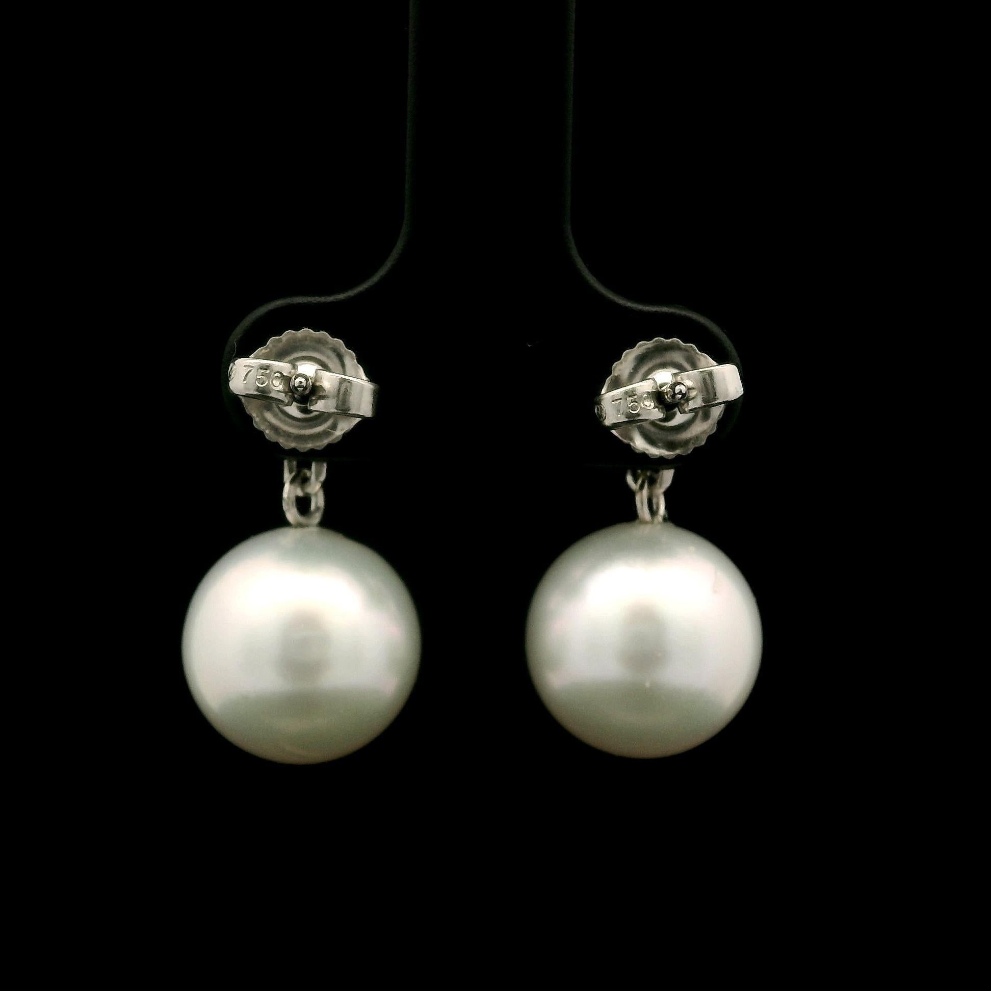 –Stone(s)–
(2) Cultured Pearls - Round Shape - Very Nice White Color - Excellent Luster - 11.6-11.7mm (approx.)
(2) Natural Genuine Diamonds - Round Brilliant Cut - Prong Set - Lively Brilliant - H Color - I1 Clarity - 1.0ctw (approx.)

Material: