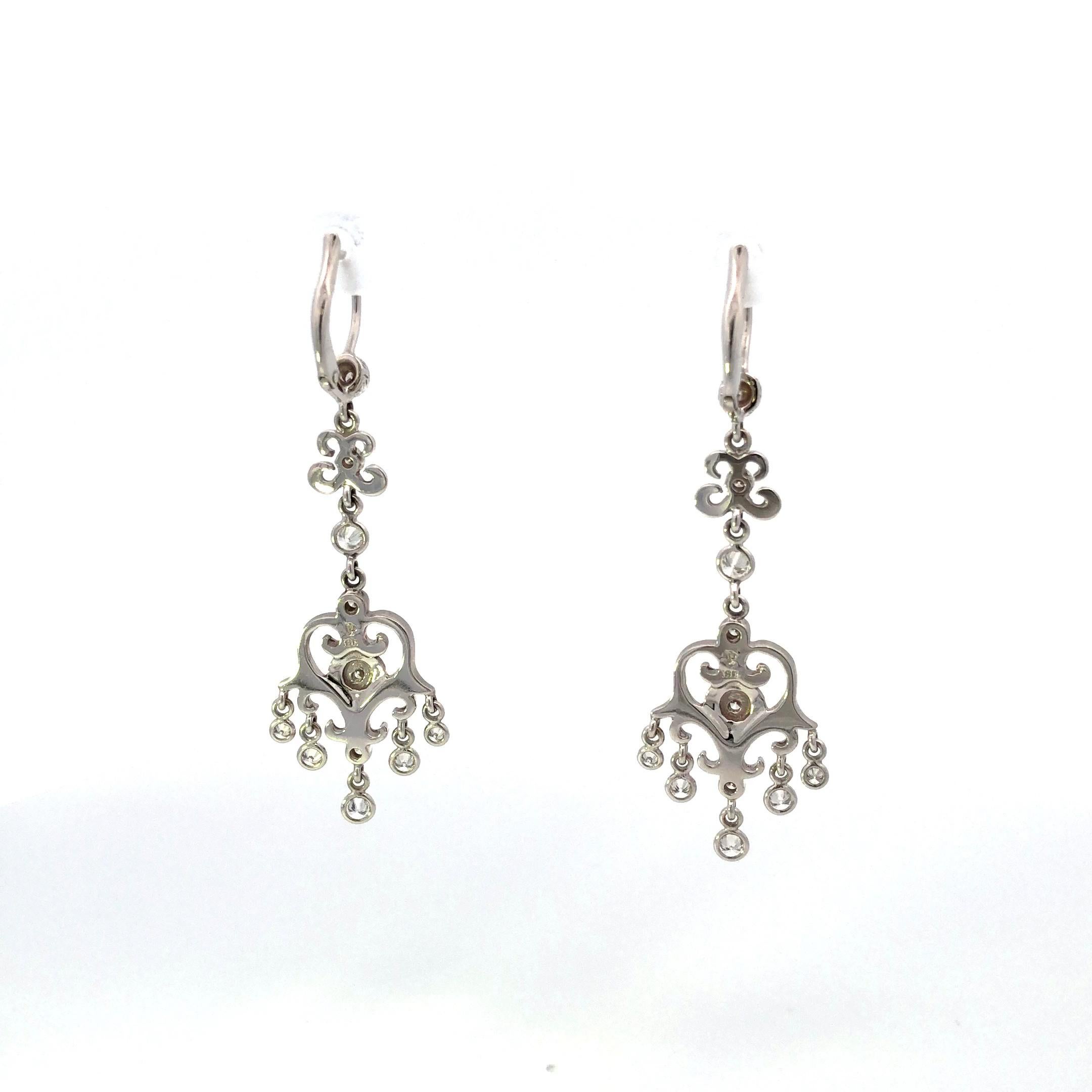 Crafted with exceptional artistry, these 18K white gold Penny Preville earrings feature a dazzling display of 22 round diamonds, totaling approximately 0.60 carats.

Designed in a chandelier style, these earrings exude a sense of luxury and