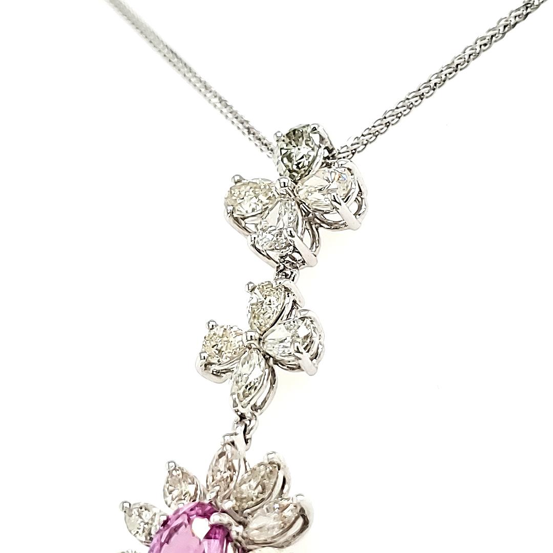 A breathtaking statement piece that will make people talk and fall in love.

This stunning necklace is crafted to perfection and has a captivating oval-cut pink sapphire that weighs 1.07 carats.

Adorning the pendant are twenty marquise diamonds,