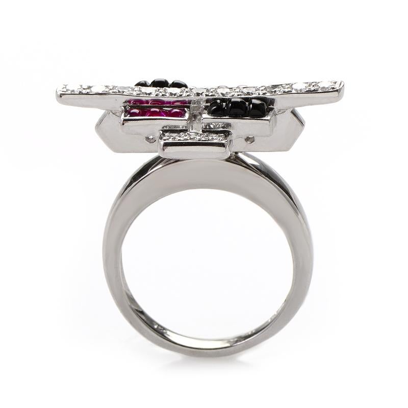 This ring is colorful and unique. It is made  of 18K white gold and boasts a design comprised of pink sapphire and onyx cabochons accented with ~.50ct of diamonds.
Ring Size: 7
