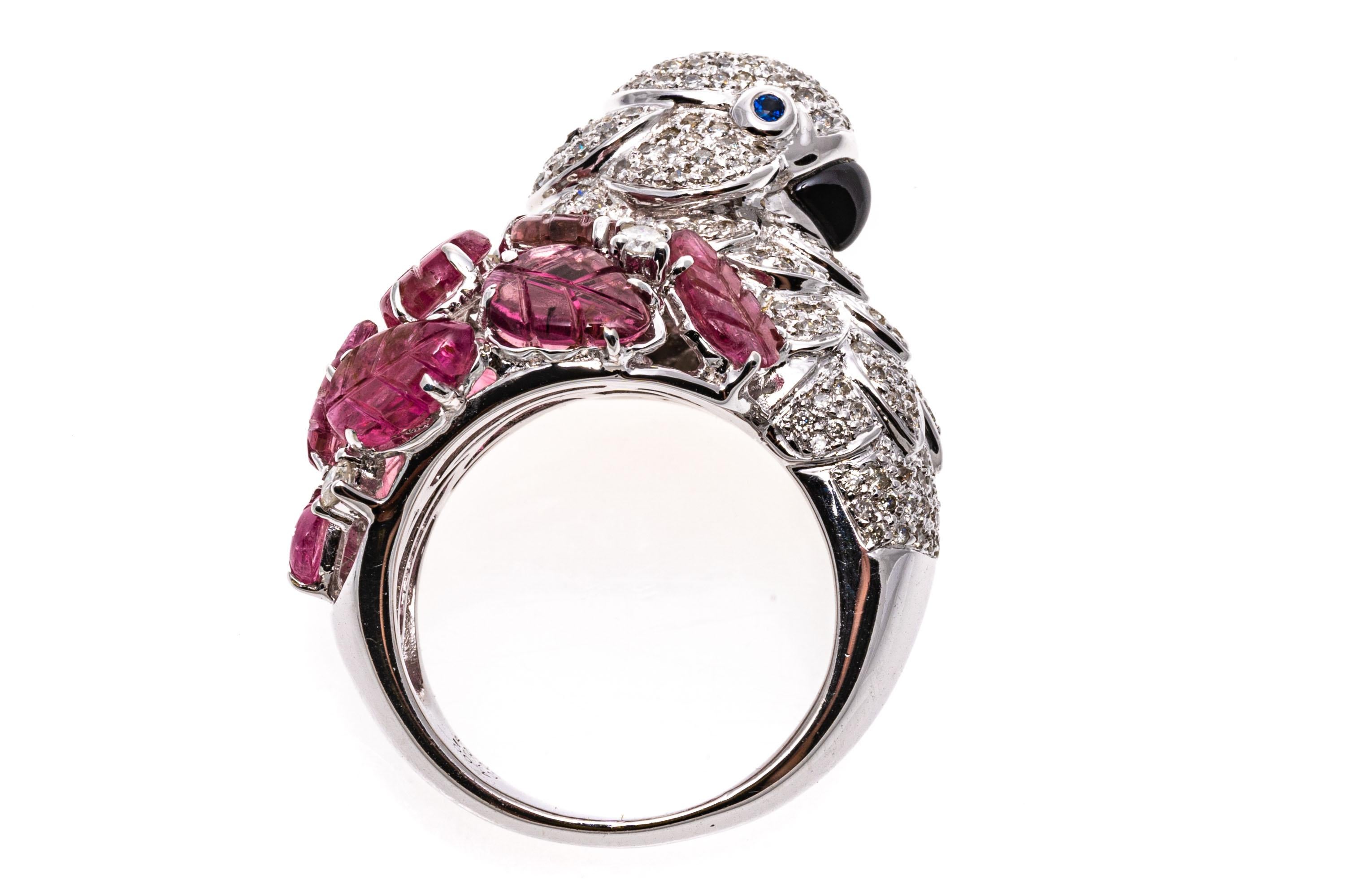 18k white gold ring. This whimsical ring is a white gold, figural flamingo, set with a head and neck of round faceted, pave diamond set feathers, 1.30 TCW, decorated with round faceted blue sapphire, bezel set eyes, 0.03 TCW and a beak made out of