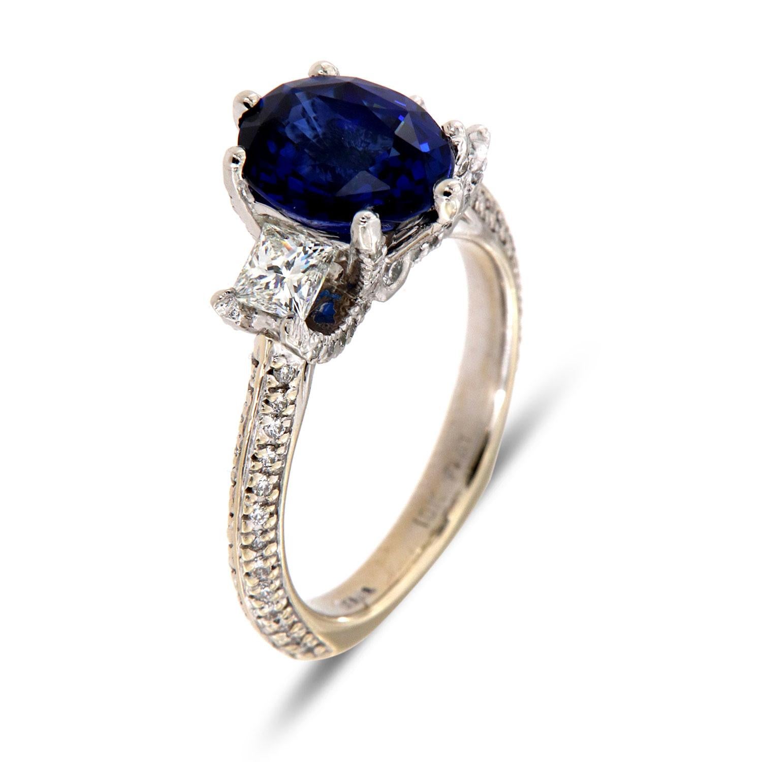 This extraordinary  18K white gold and platinum ring feature a Top Quality 3.54 - carat Blue Oval shape Natural Sapphire  GIA Certificate:2205223812 flanked by perfectly matched Two (2) Princess shape diamonds set within six (6) Delicate prongs.