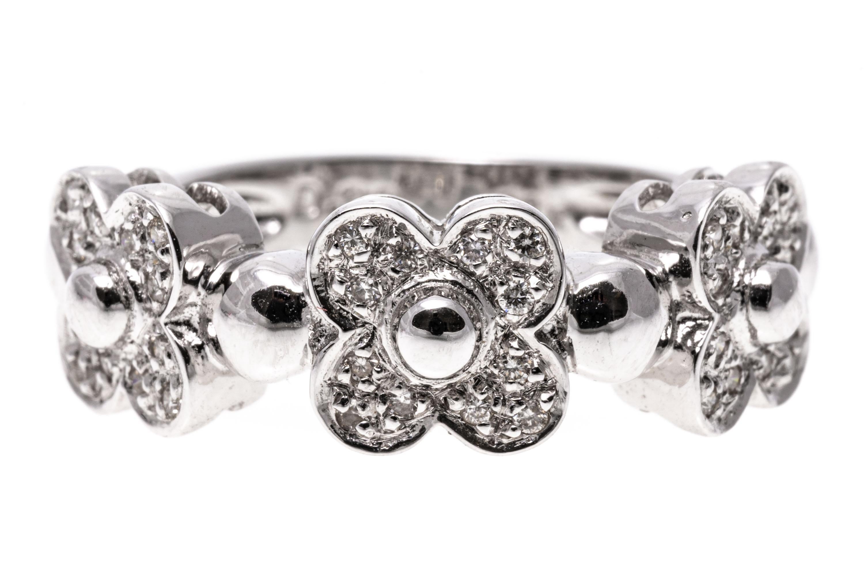 18k white gold ring. This charming ring has three, quatrefoil flowers, with round faceted, pave set petals, 0.20 TCW, alternating with round high polished domes..
Marks: 18k
Dimensions: 15/16