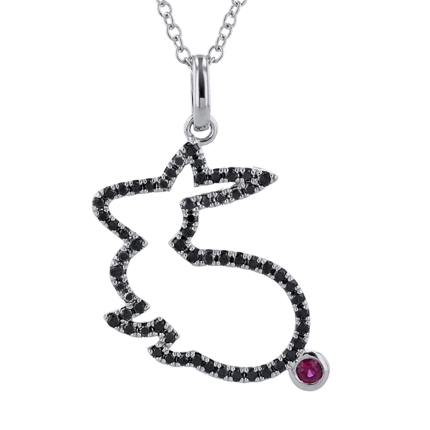 This cross pendant is made in 18K white gold and features a rabbit shape pendant with 61 round cut, prong set black diamonds. With a round cut, bezel set 0.05ct ruby and a white gold carrot charm that includes 1 bezel set, 0.32ct. white diamond.