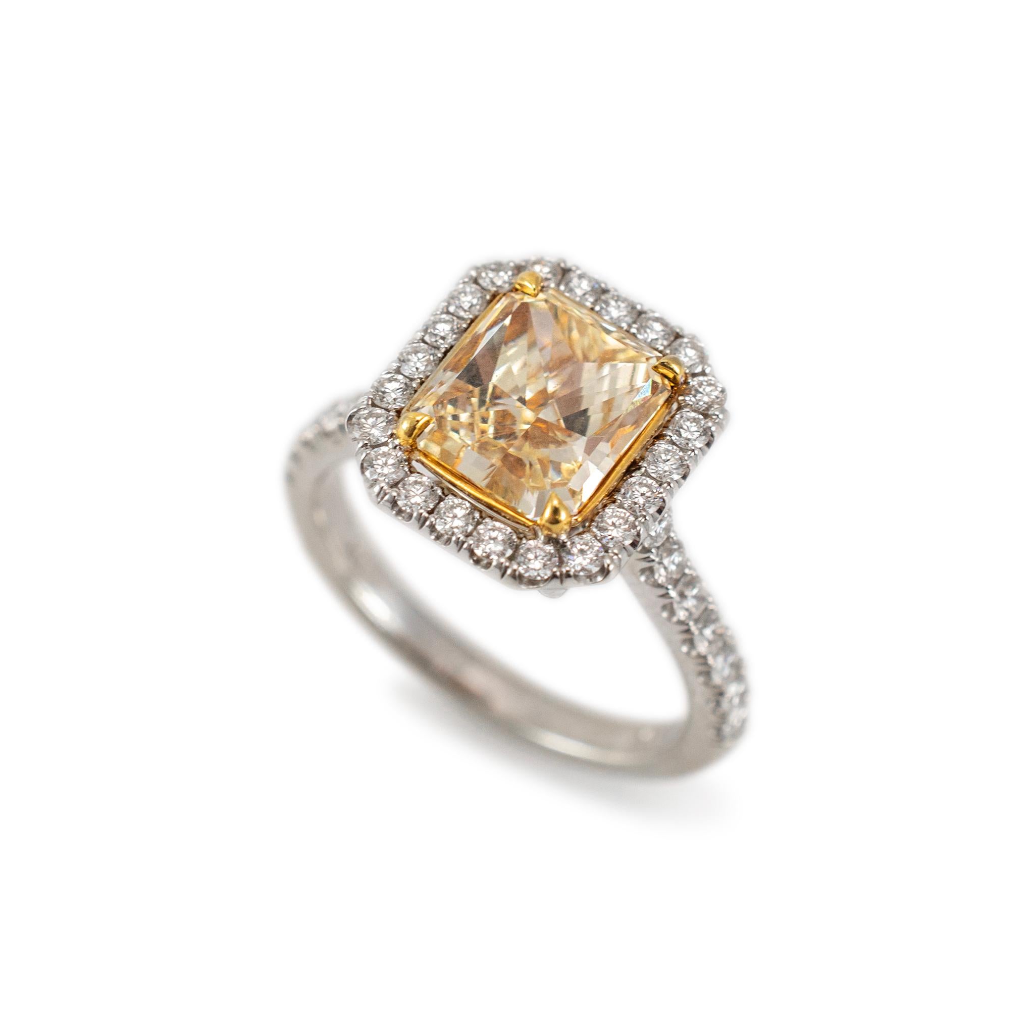 Gender: Ladies 

Metal Type: 18K White & Yellow Gold

Ring Size: 6.5 

Weight: 5.83 grams

Shank maximum width: 2.00mm

One ladies 18K white & yellow gold diamond engagement halo accented ring with a half round shank. The metal was tested and